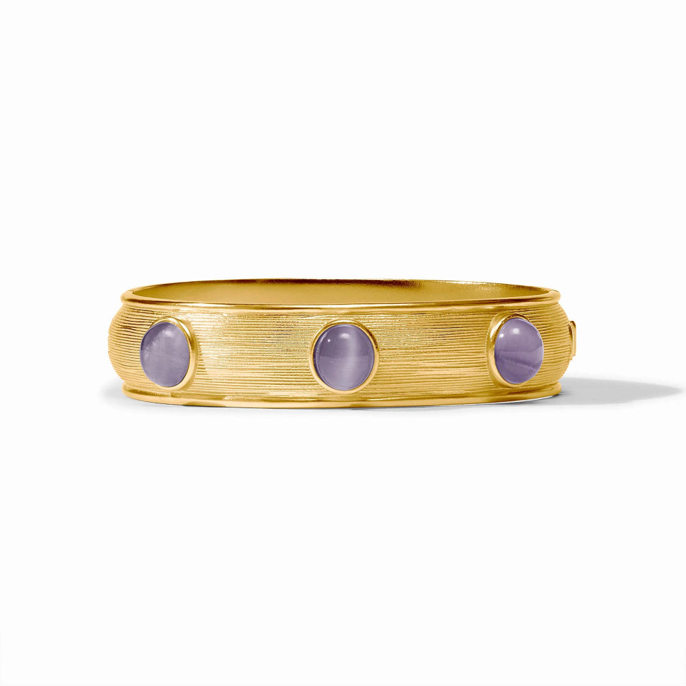 Gold bracelet with three purple gemstones on a white background