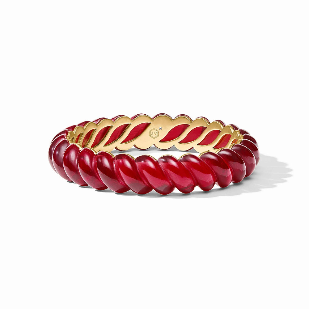 A gold bangle bracelet with a glossy deep red twisted bead border, shown on a clean white background with a soft shadow.