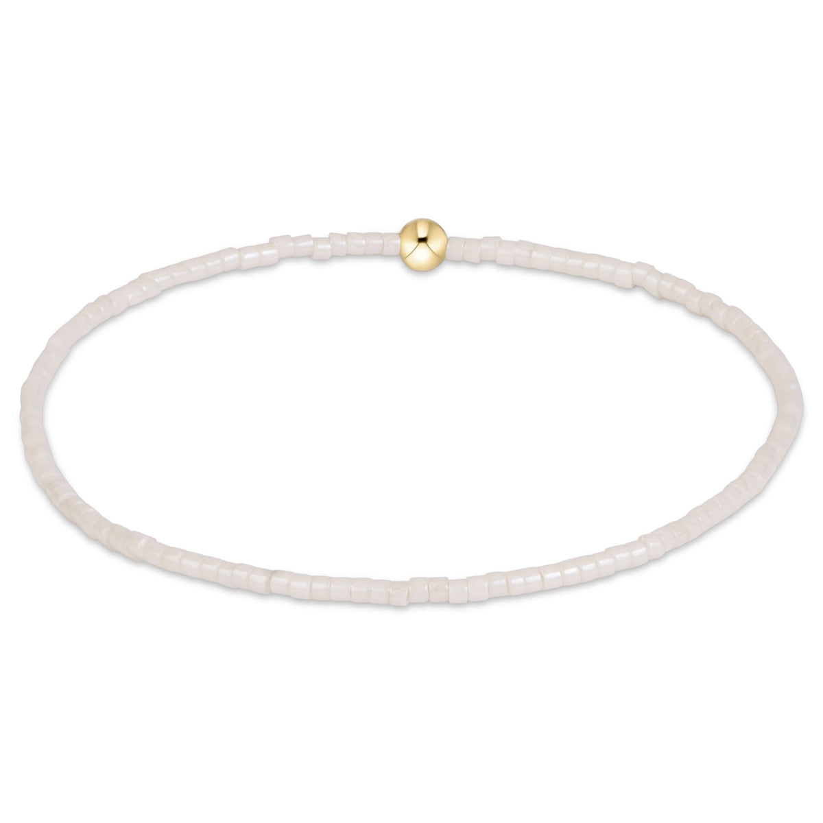 A delicate beaded bracelet made of small translucent white beads with a single polished gold bead accent at the top, shown on a plain white background.