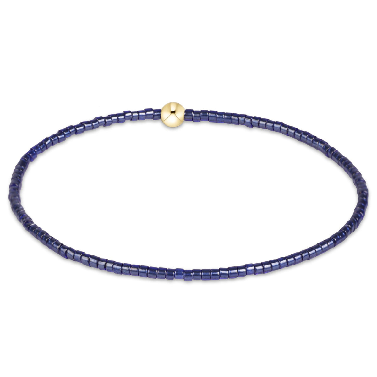 A delicate beaded necklace featuring deep blue faceted beads and a small, polished gold round clasp, displayed on a clean white background.