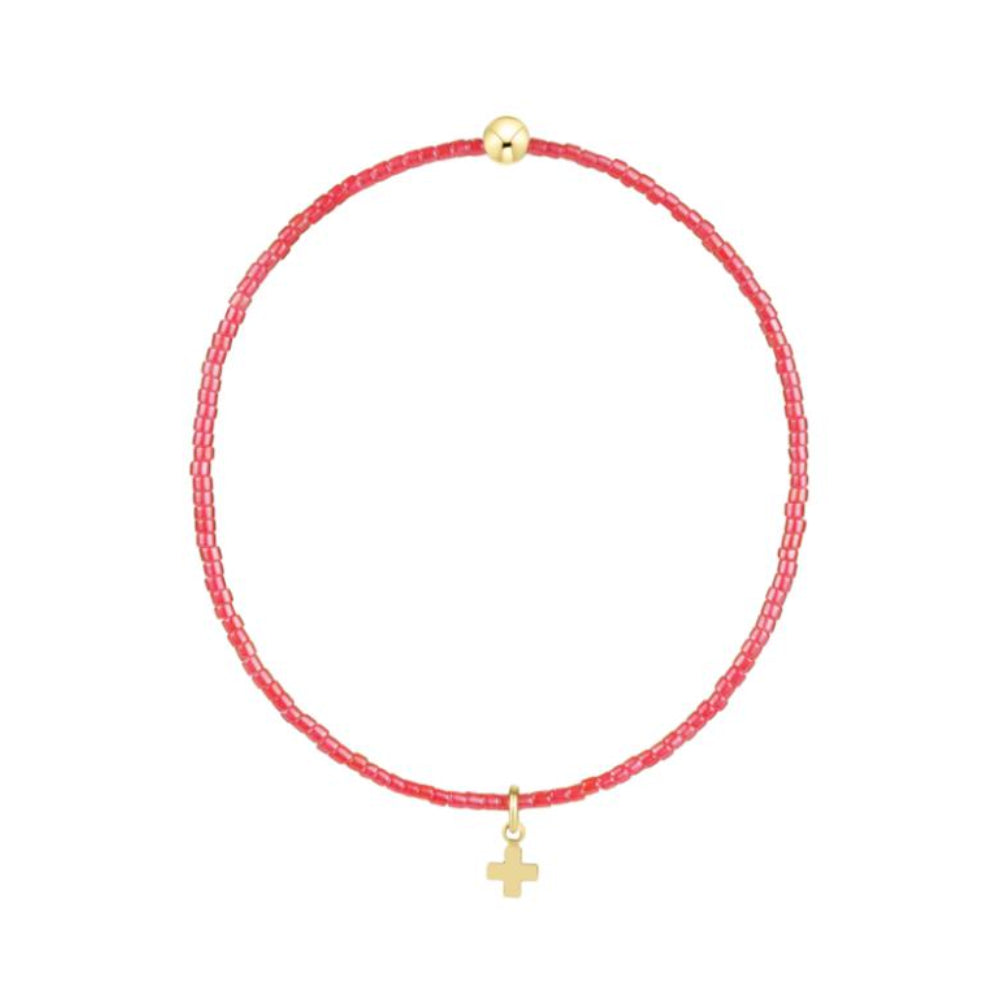 Red beaded bracelet with a gold cross charm on a white background
