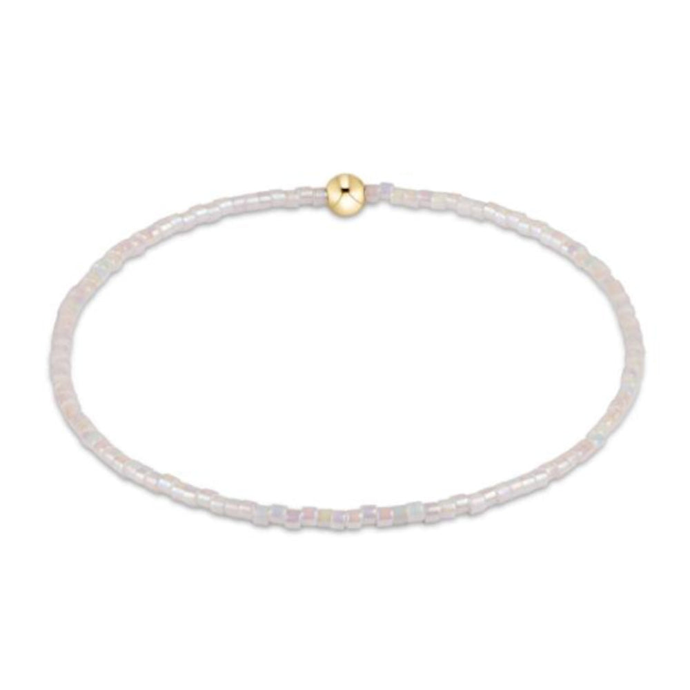 Delicate bracelet with a gold bead on a white background
