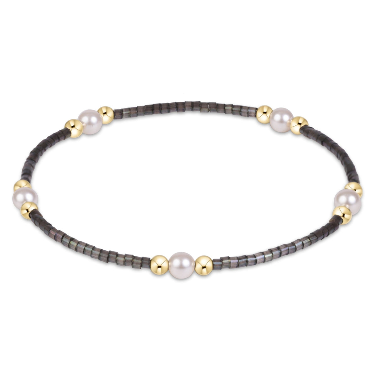 A delicate beaded bracelet featuring dark gray gunmetal beads, white pearl-like beads, and small gold spacer beads, displayed on a clean white background.