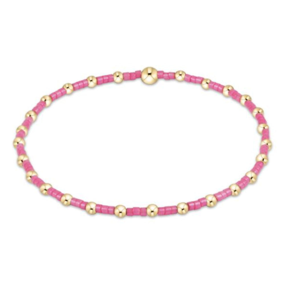 Bracelet with pink beads and gold accents on a white background