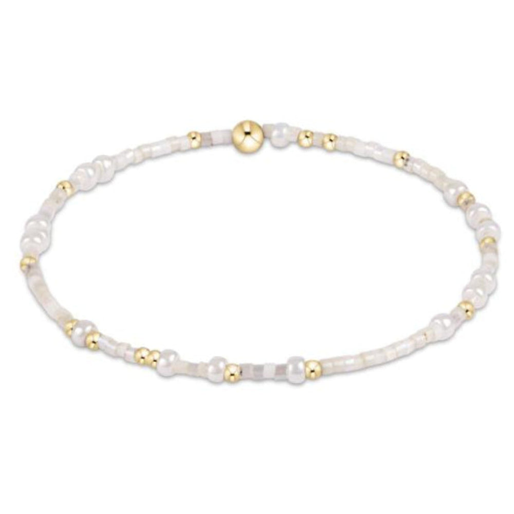 Pearl , white and gold beaded bracelet on a white background