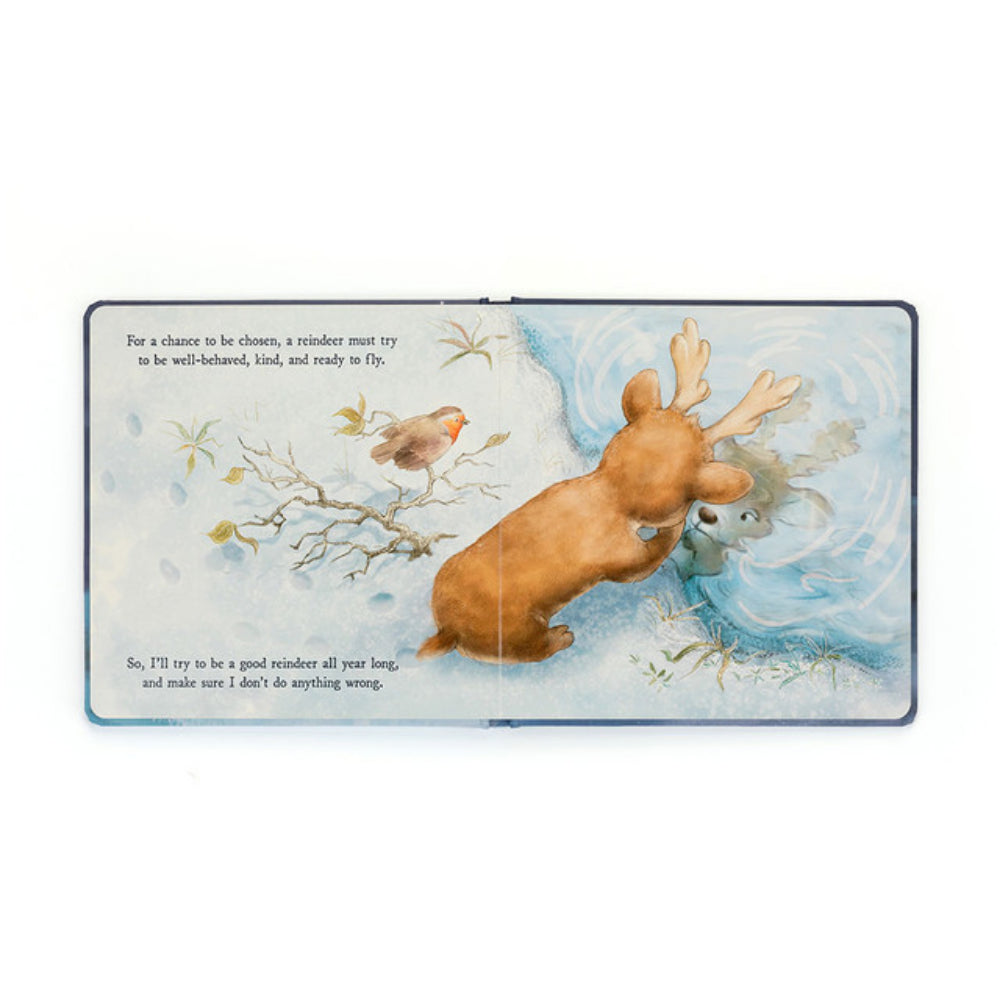 Inside of the 'Mitzi Reindeer's Dream' book with a reindeer in the snow looking at its reflection in the ice with black story book text. 