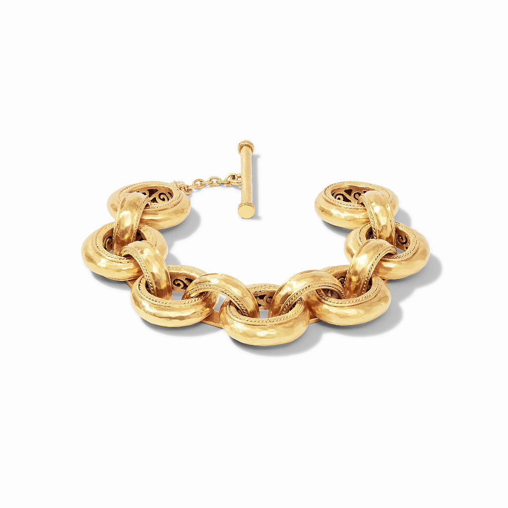 A chunky gold chain link bracelet with a toggle clasp, displayed on a clean white background.