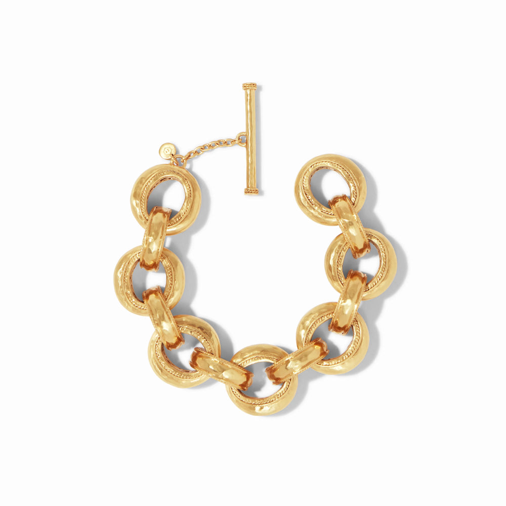 A gold chain link bracelet with a toggle clasp, displayed on a clean white background.