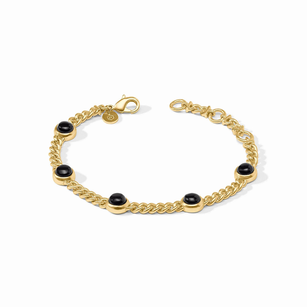 Gold bracelet with black beads on a white background