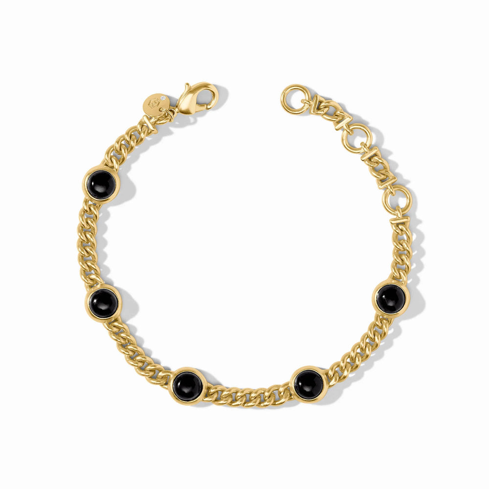 A gold chain bracelet with five evenly spaced round black onyx beads, displayed on a clean white background.