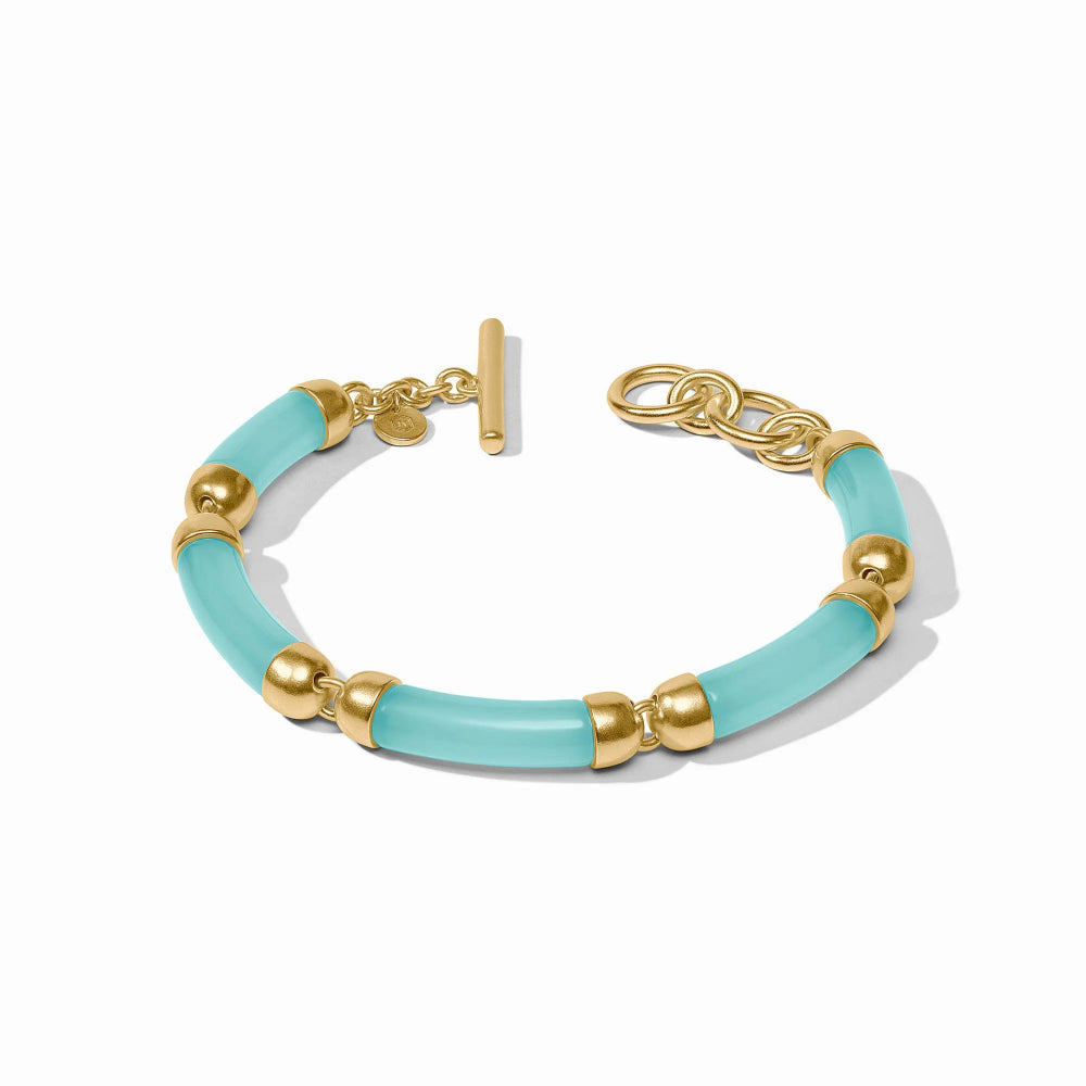 Bracelet with gold accents and light blue beads on a white background