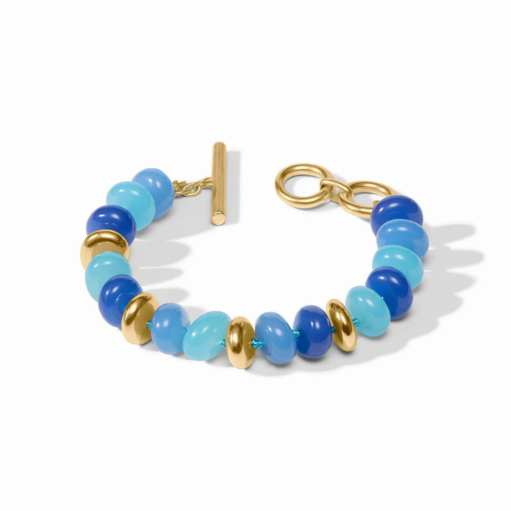 Bracelet with blue and gold beads on a white background
