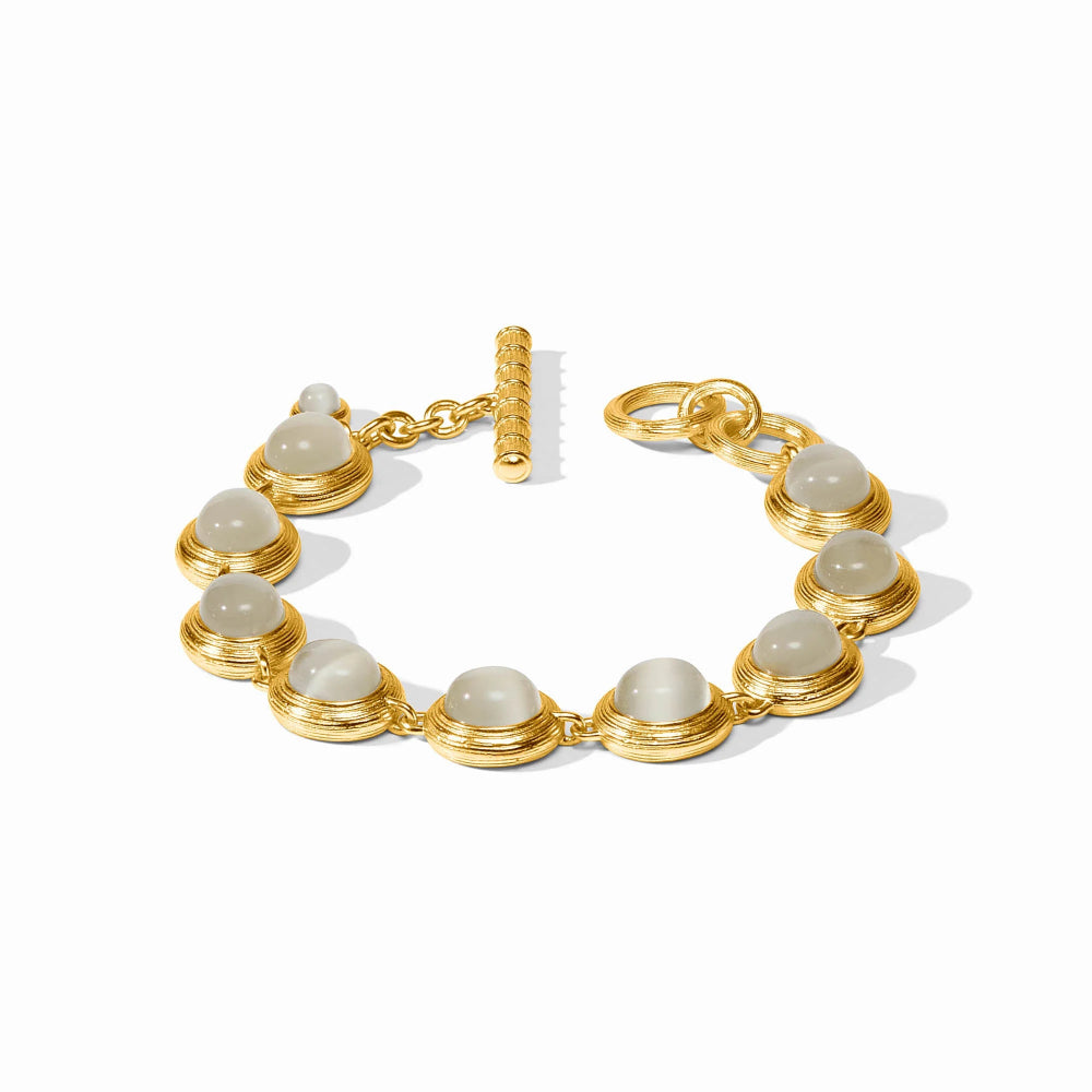A gold-plated bracelet featuring multiple oval cabochon gemstones in a gold bezel setting, complete with a toggle clasp, shown on a clean white background.