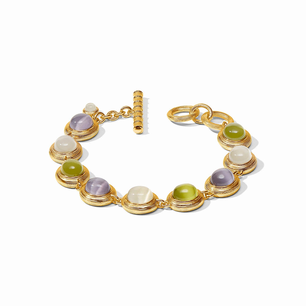 Gold bracelet with multicolored gemstones on a white background