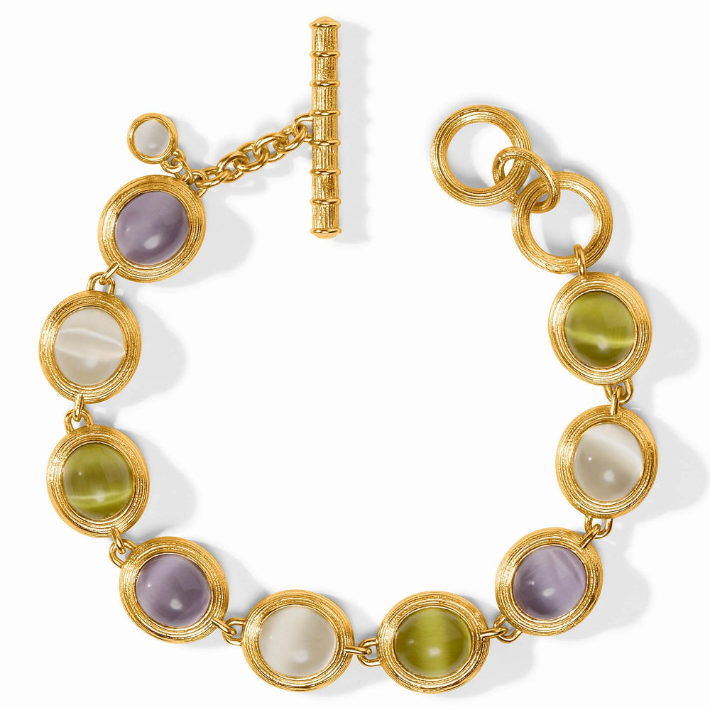 Gold bracelet with multicolored gemstones on a white background