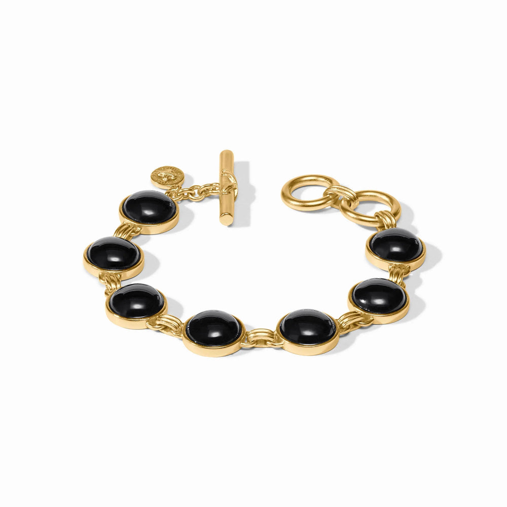 Gold bracelet with black stones on a white background