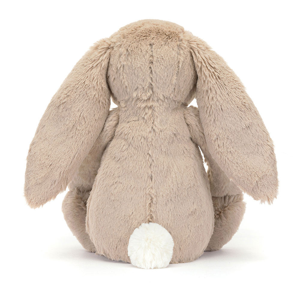 A photo of the back of the original/medium size beige plush bunny toy with floral patterned ears and feet in a white backround. 