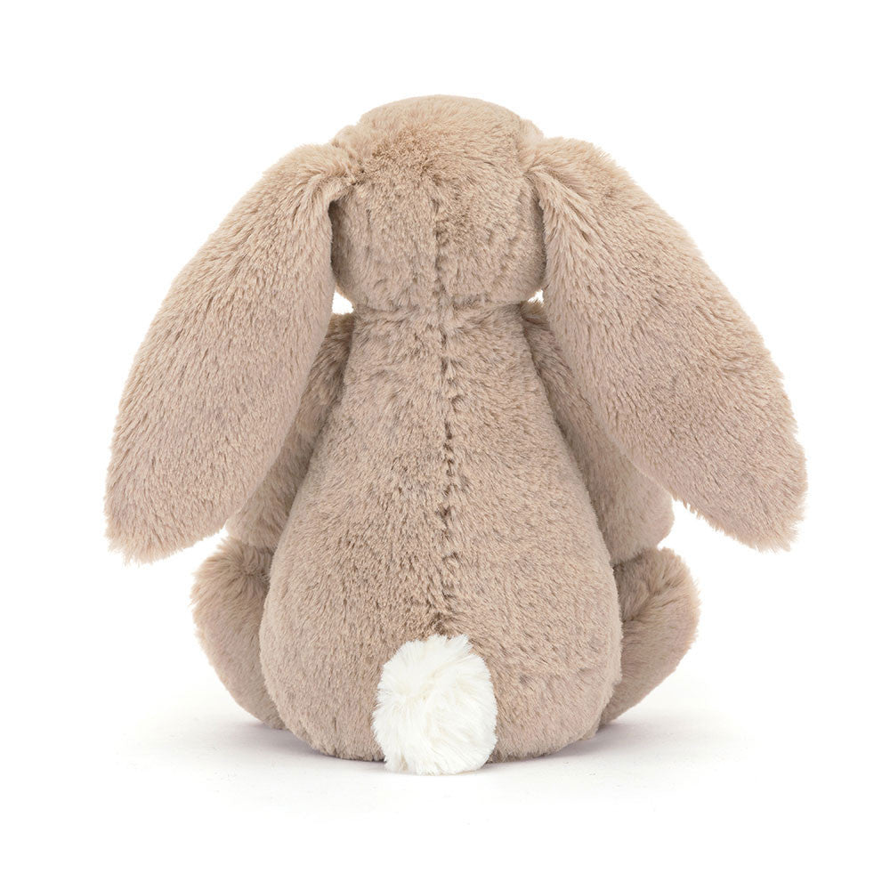 A photo of the back of a Litte sized plush bunny toy with floral ears and feet on a white background.