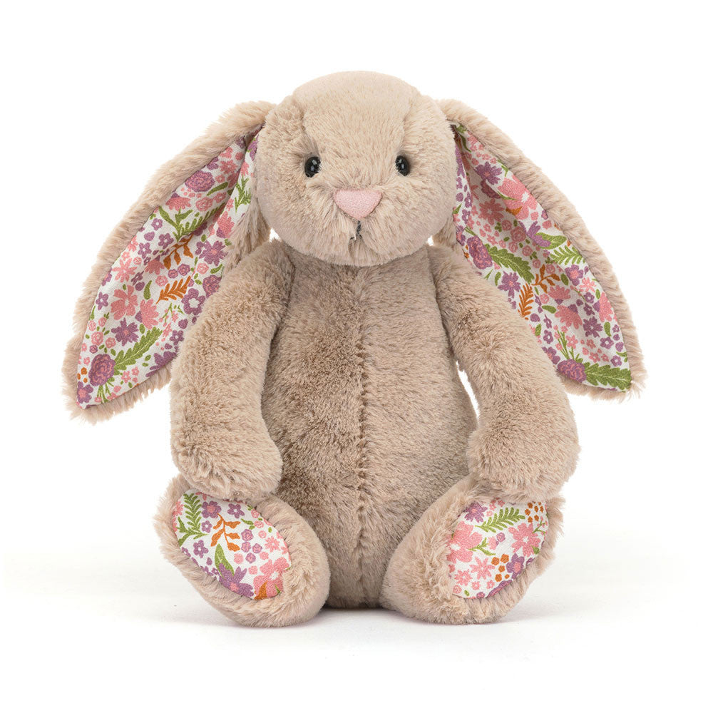 Litte sized plush bunny toy with floral ears and feet on a white background.