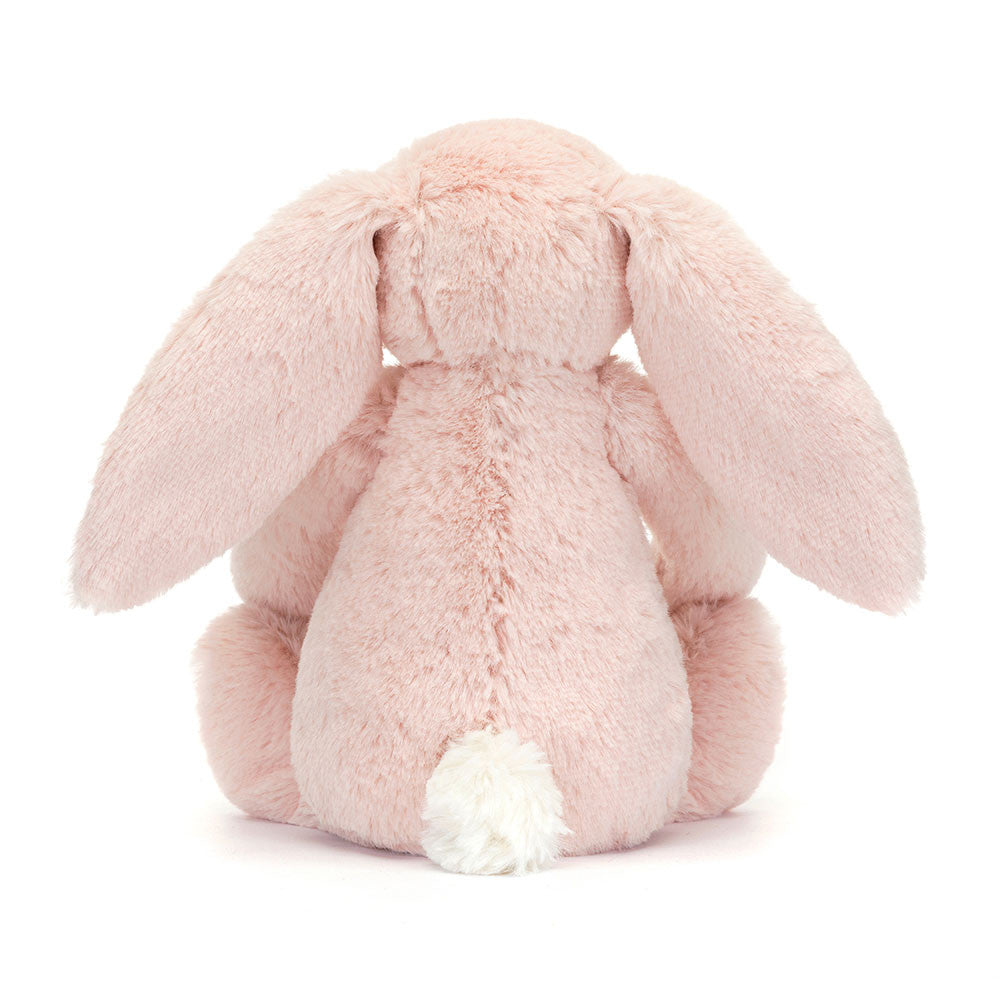 The back of a Little sized pink plush bunny with  floral-patterned ears on a white background.