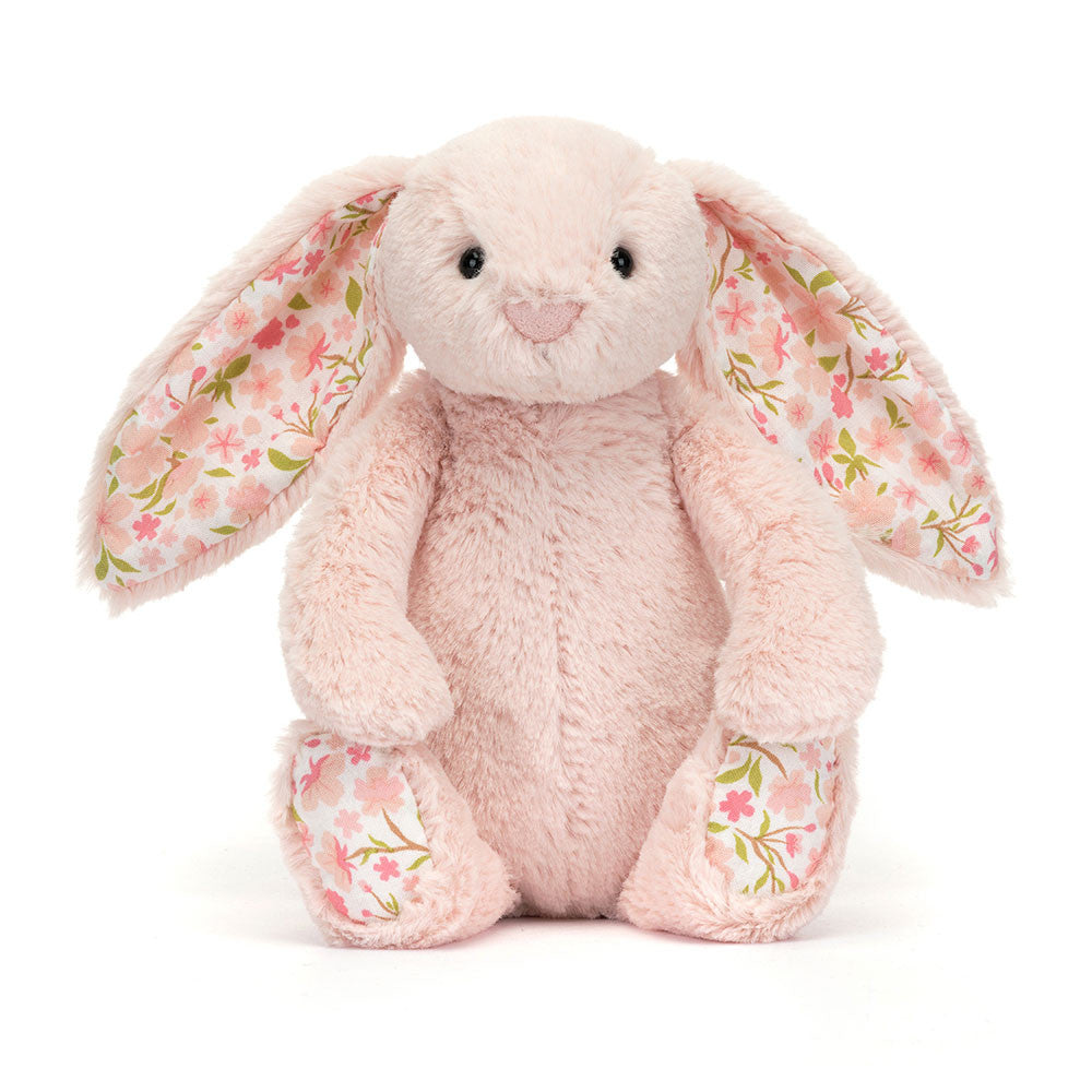 The front of a Little sized pink plush bunny with  floral-patterned ears on a white background.