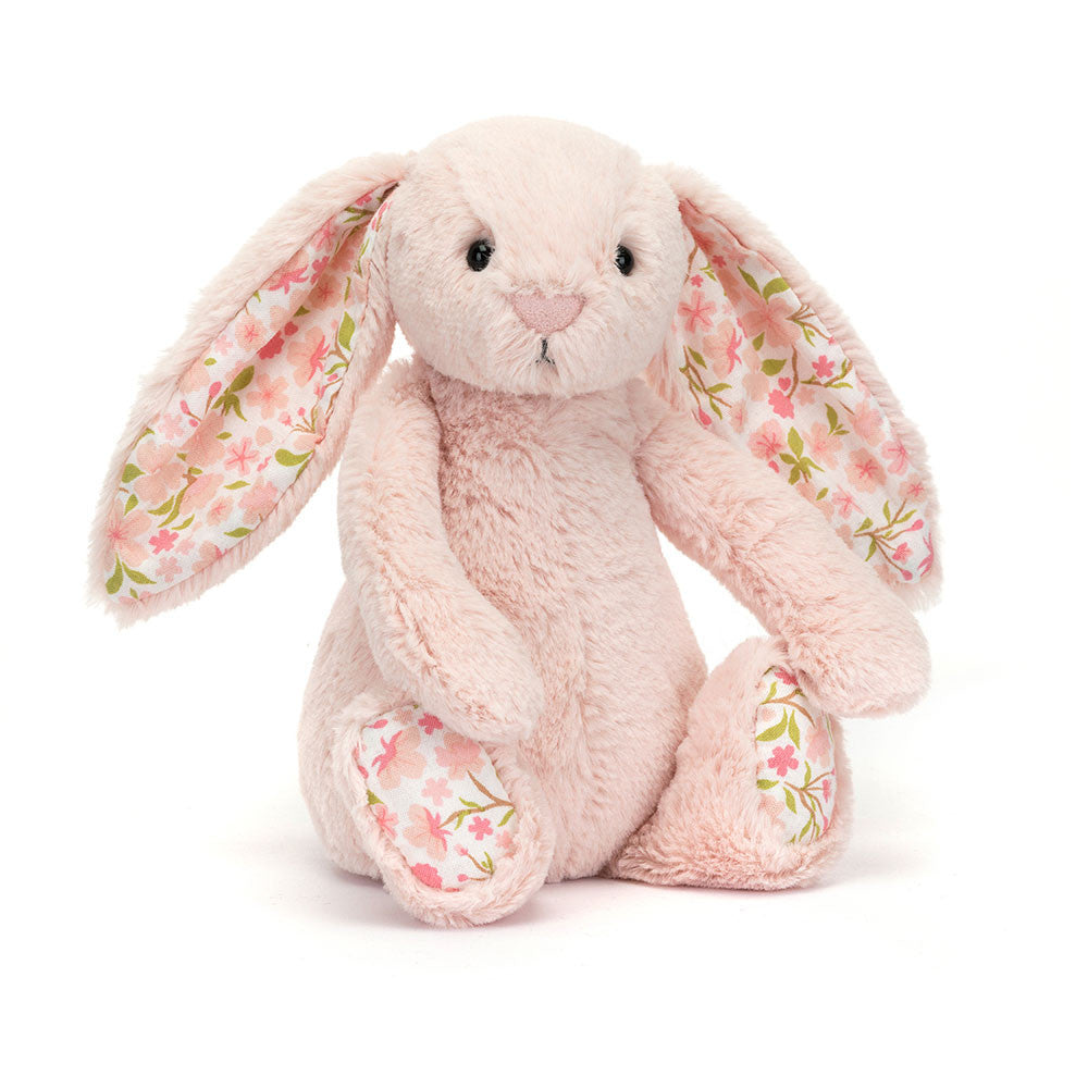 Big sized pink plush bunny with  floral-patterned ears on a white background.