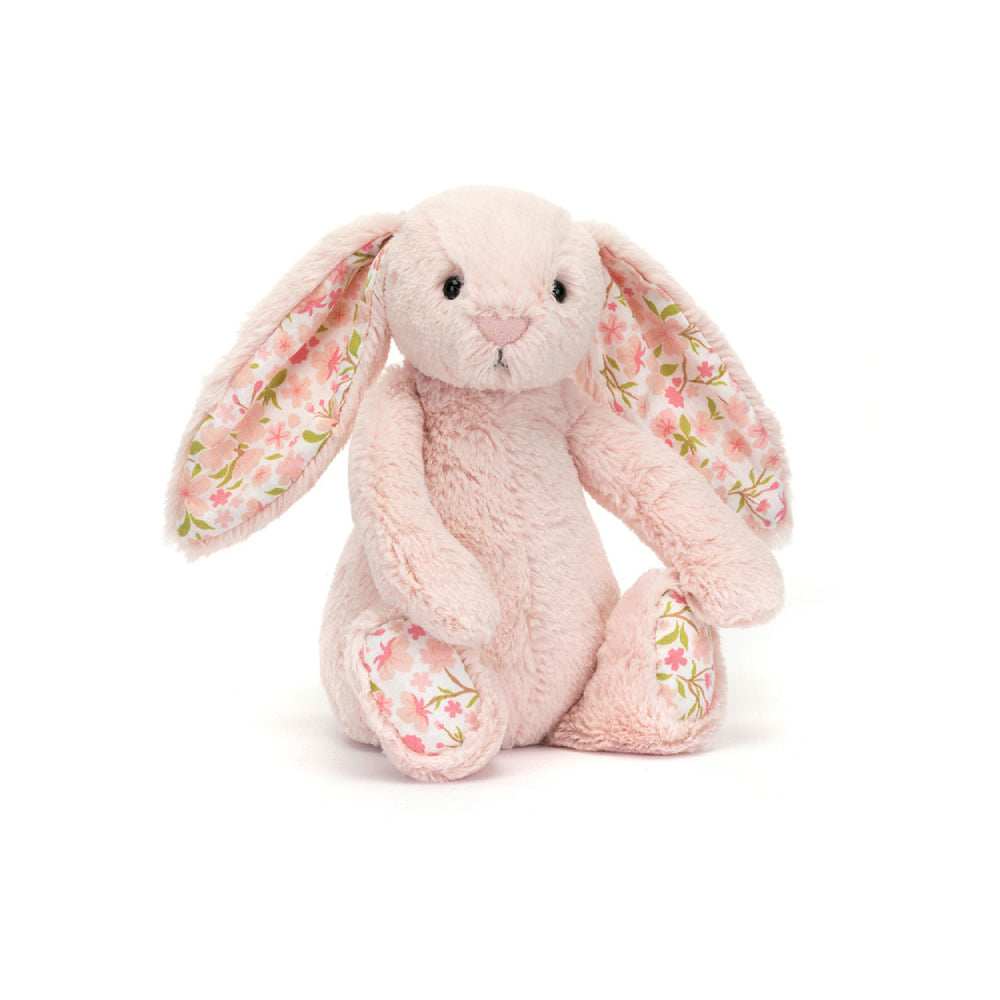 Little sized pink plush bunny with  floral-patterned ears on a white background.