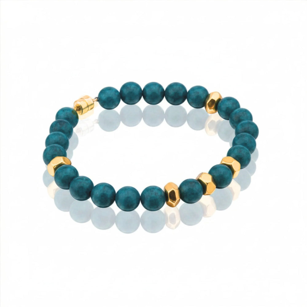 A beaded bracelet featuring matte dark teal-green round beads and polished gold-tone hexagonal spacer beads, displayed on a clean white background with a soft reflection.