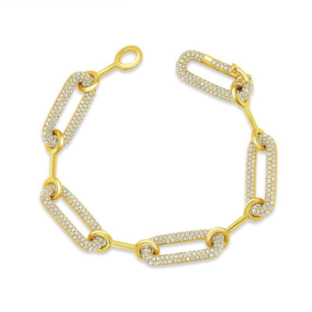 Gold bracelet with polished plain and pave diamond links on a white background