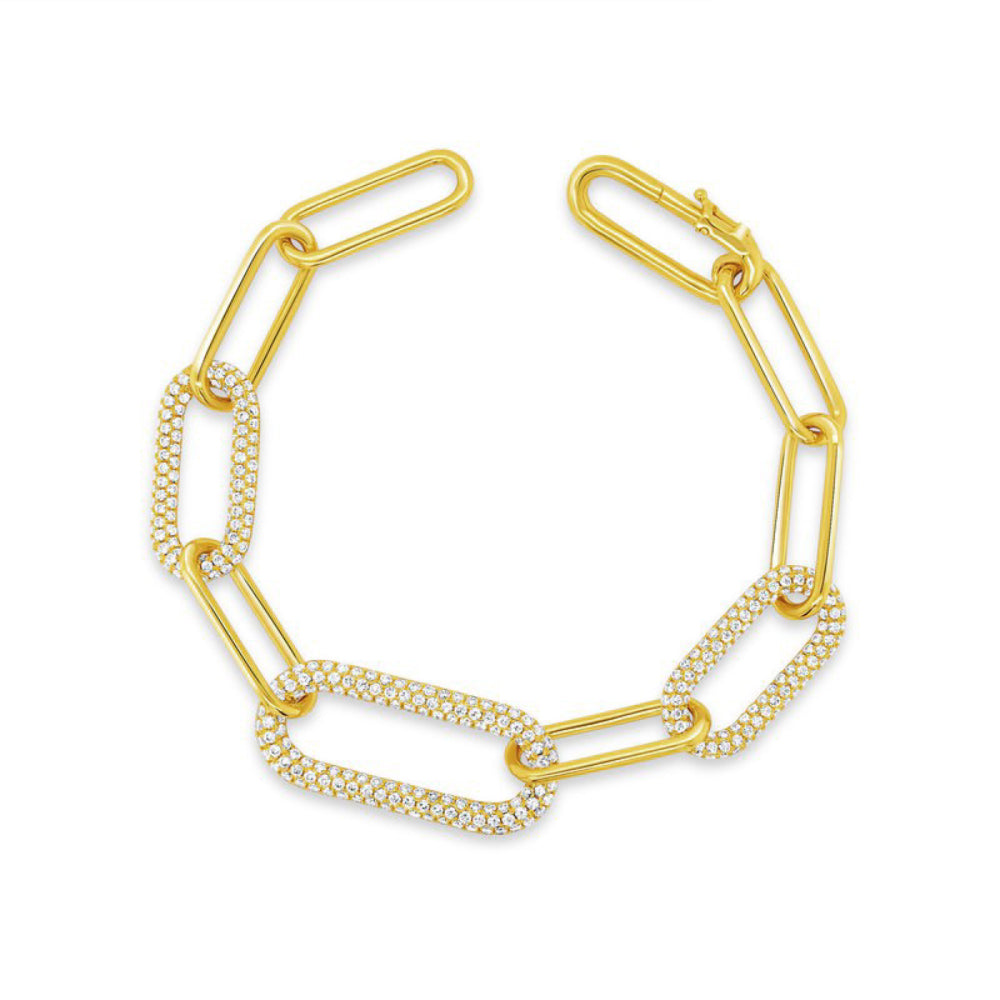 Gold chain bracelet with interlocking diamond and polished plain links on a white background