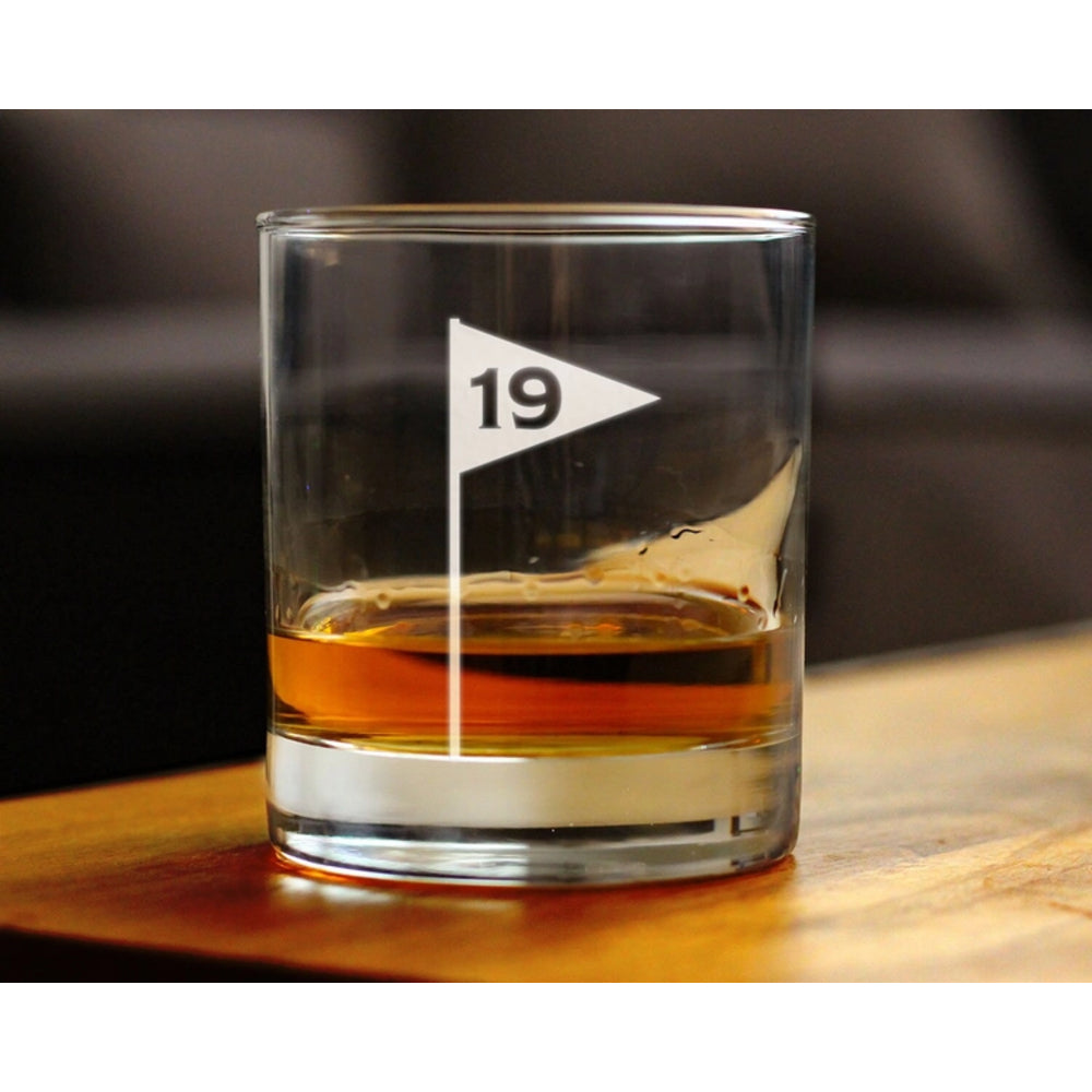 Glass with a triangle flag and number 19 on a wooden surface