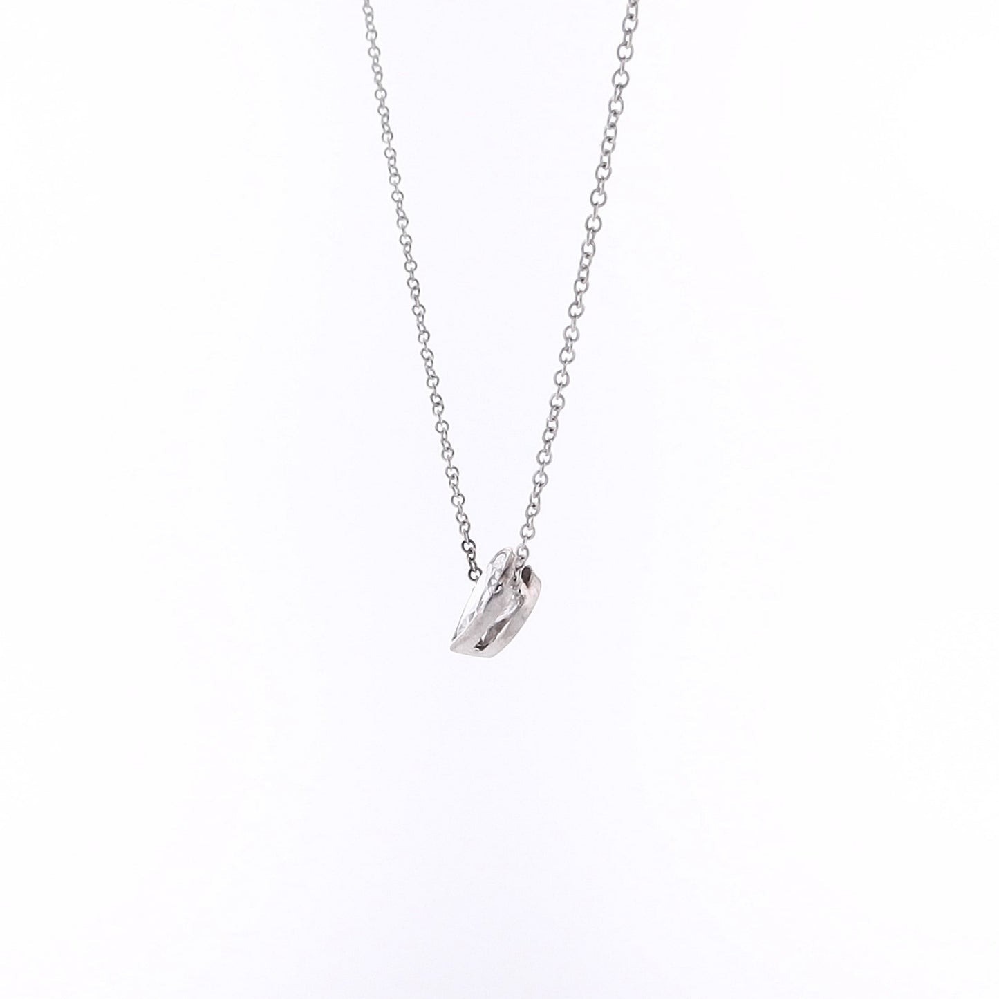 Pear shape diamond pendant necklace on a white background