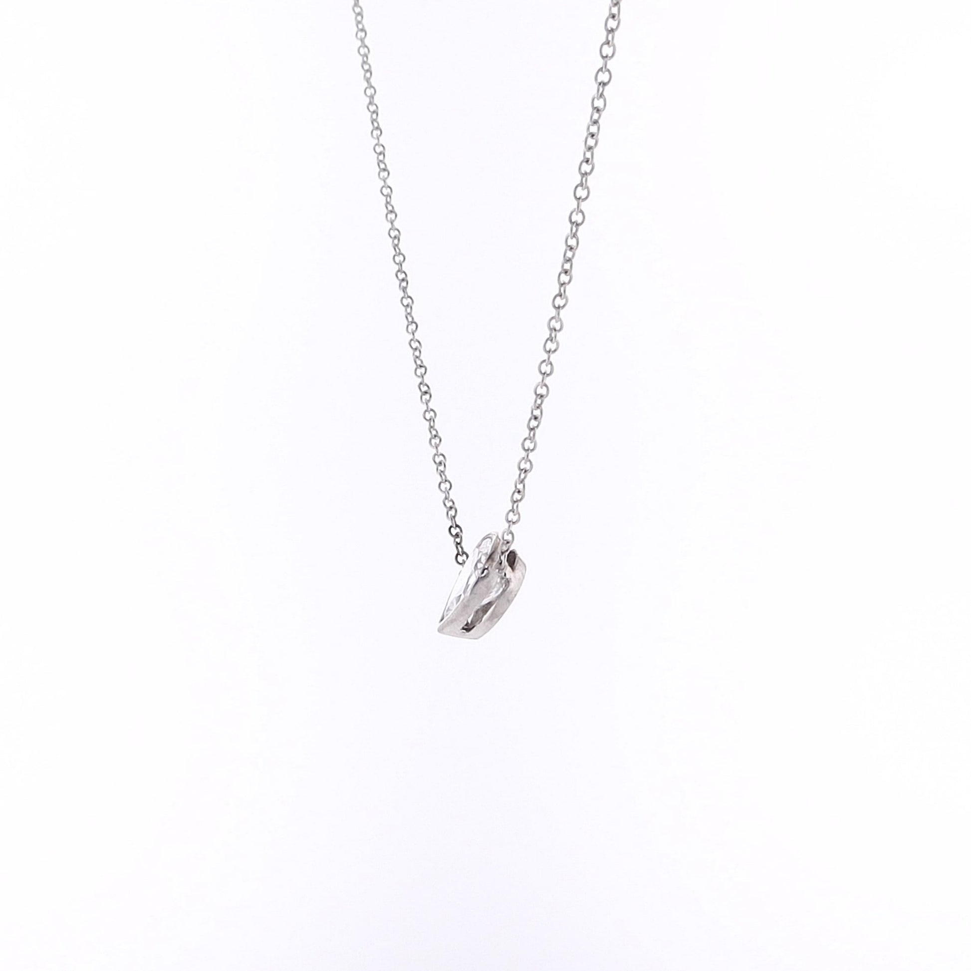 Pear shape diamond pendant necklace on a white background