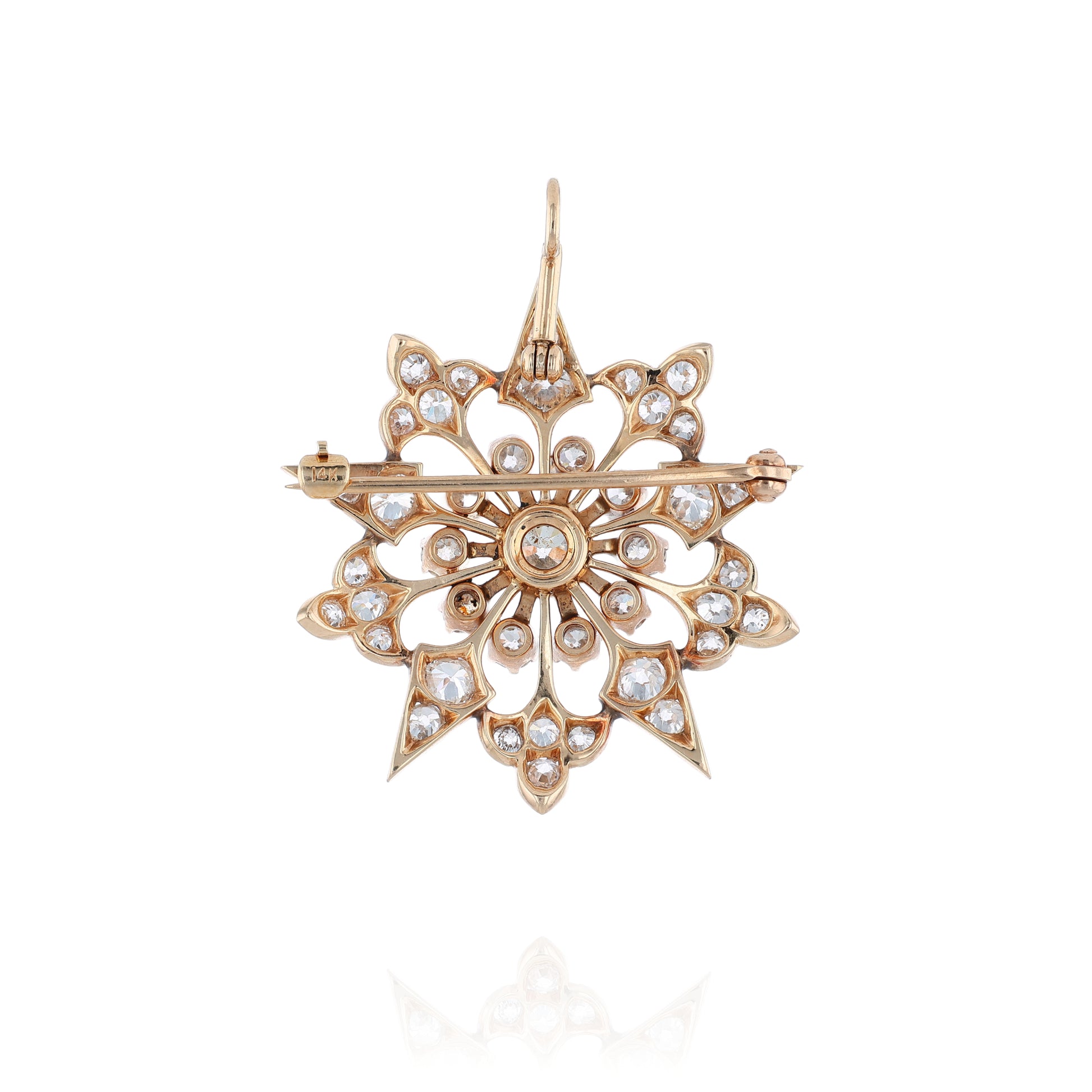 Yellow gold modular pin or pendant with diamond accents on a white background