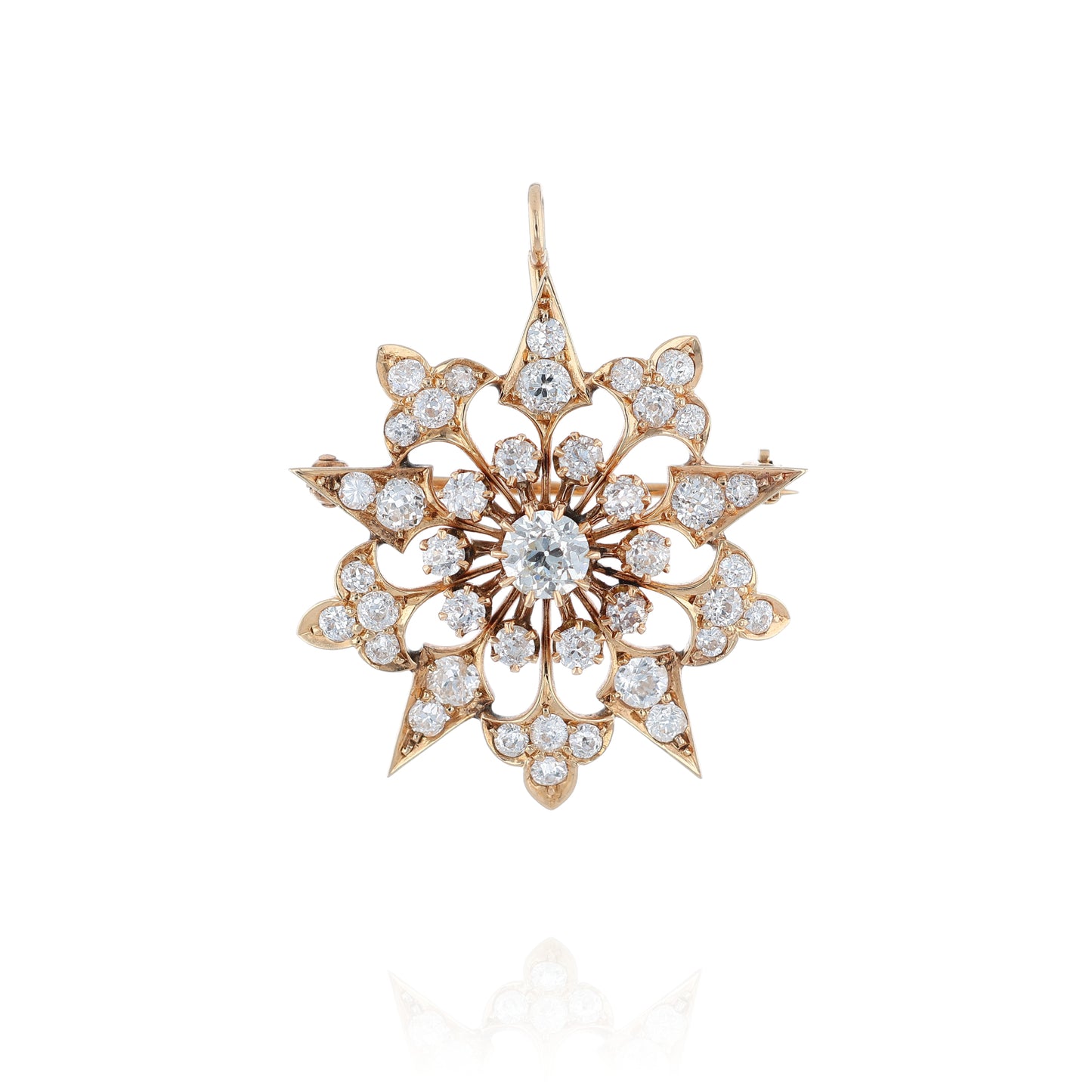 Yellow gold modular pin or pendant with diamond accents on a white background