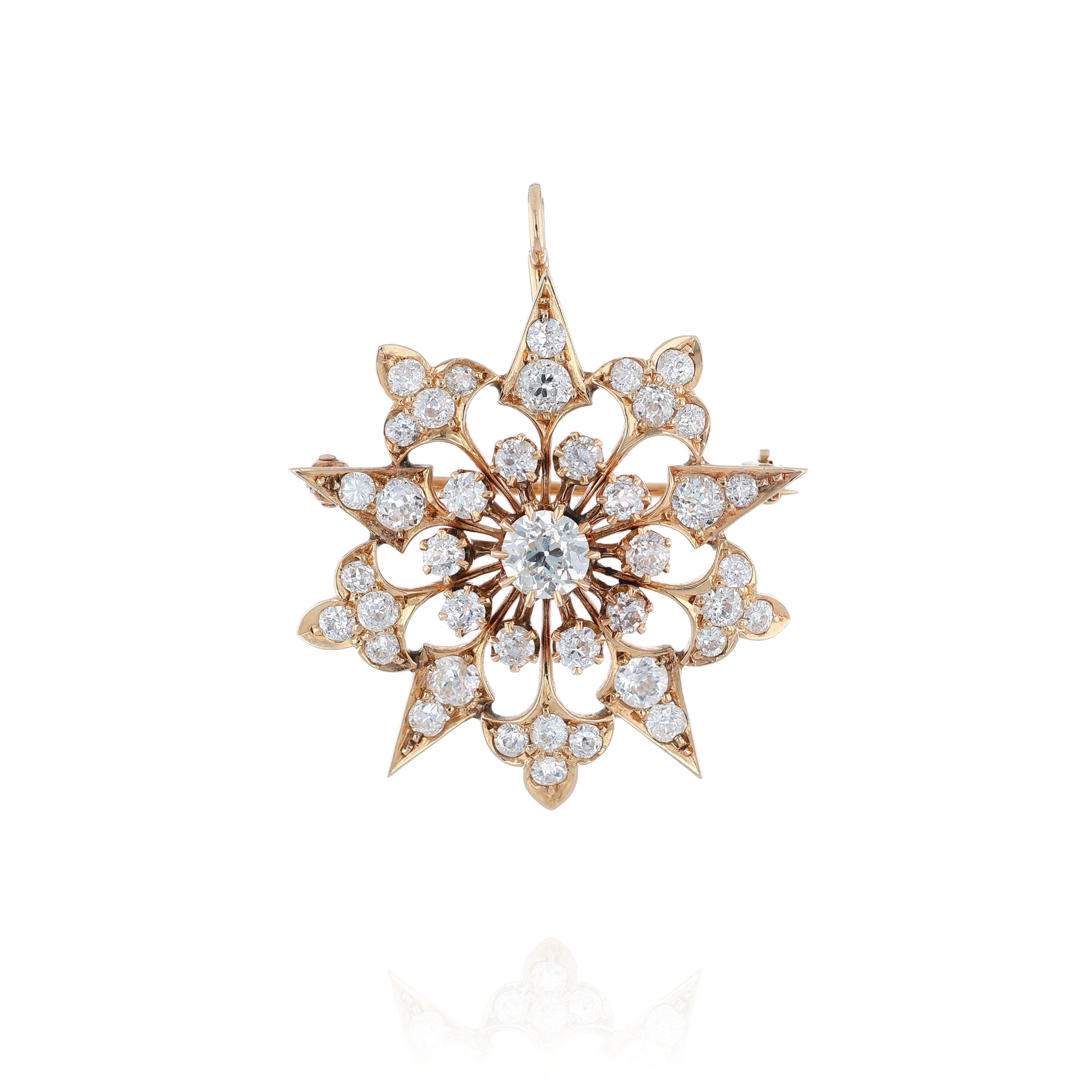 Yellow gold modular pin or pendant with diamond accents on a white background