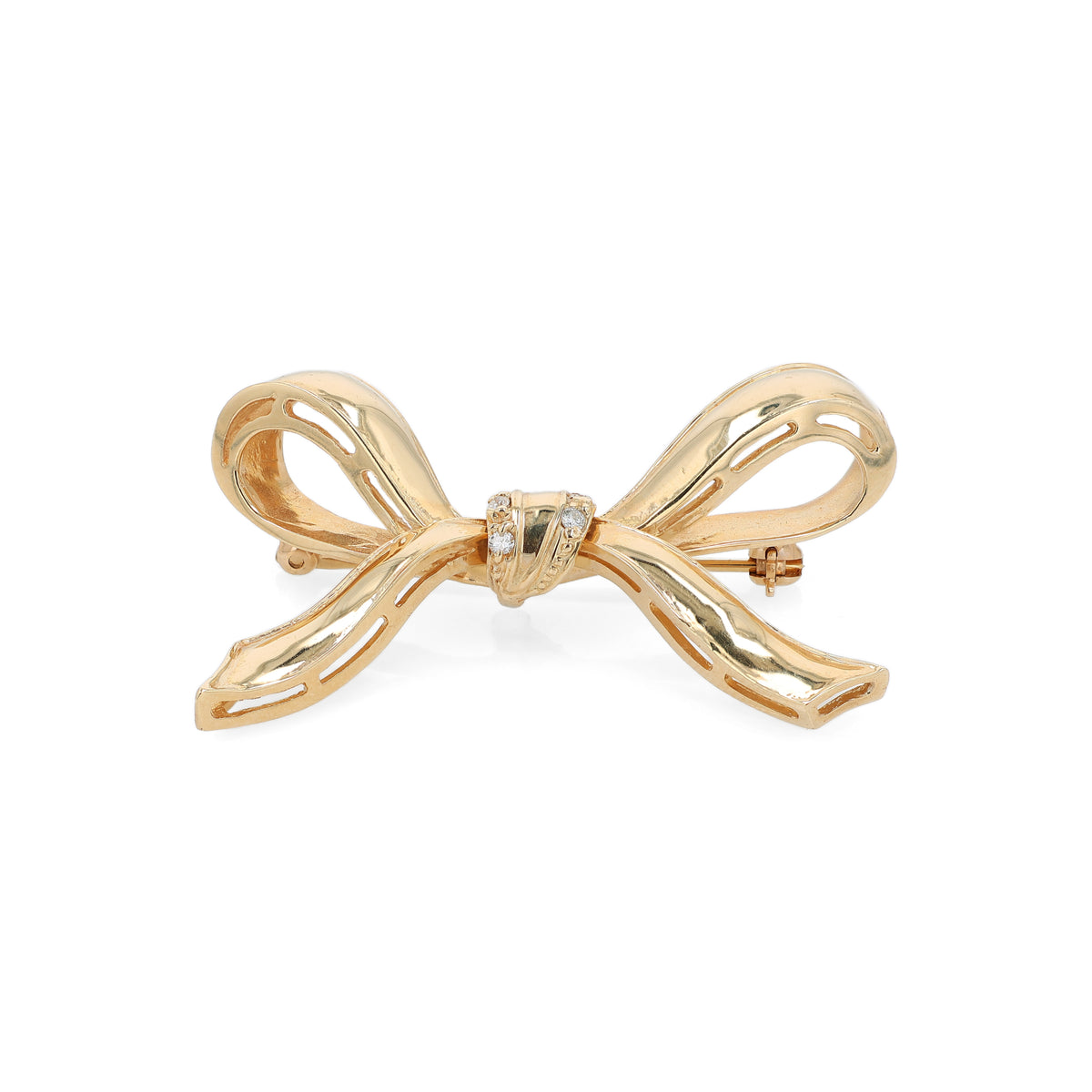 A polished gold bow-shaped brooch with a small cluster of diamonds at the center, shown on a plain white background.