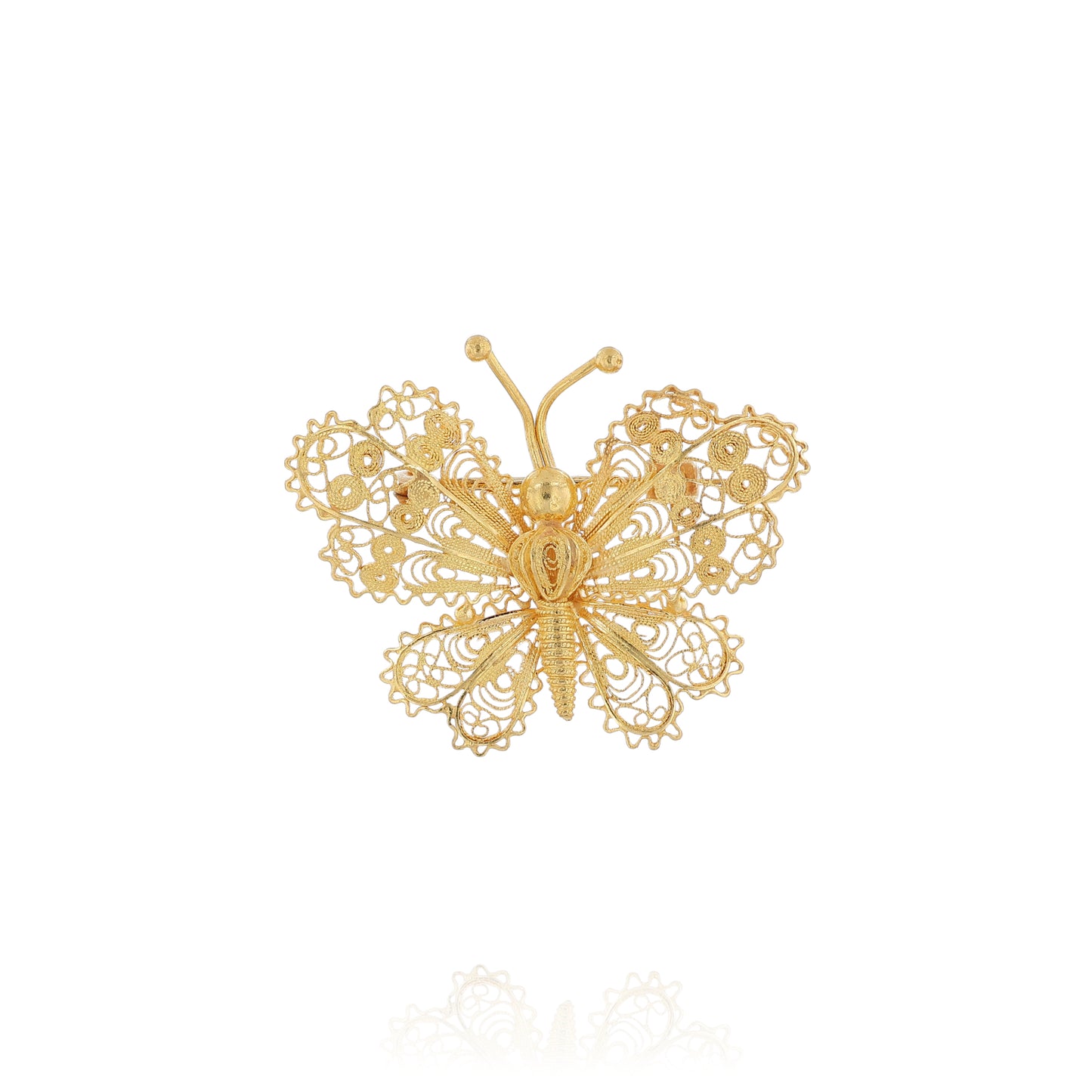 Yellow gold filigree design butterfly pin on a white background