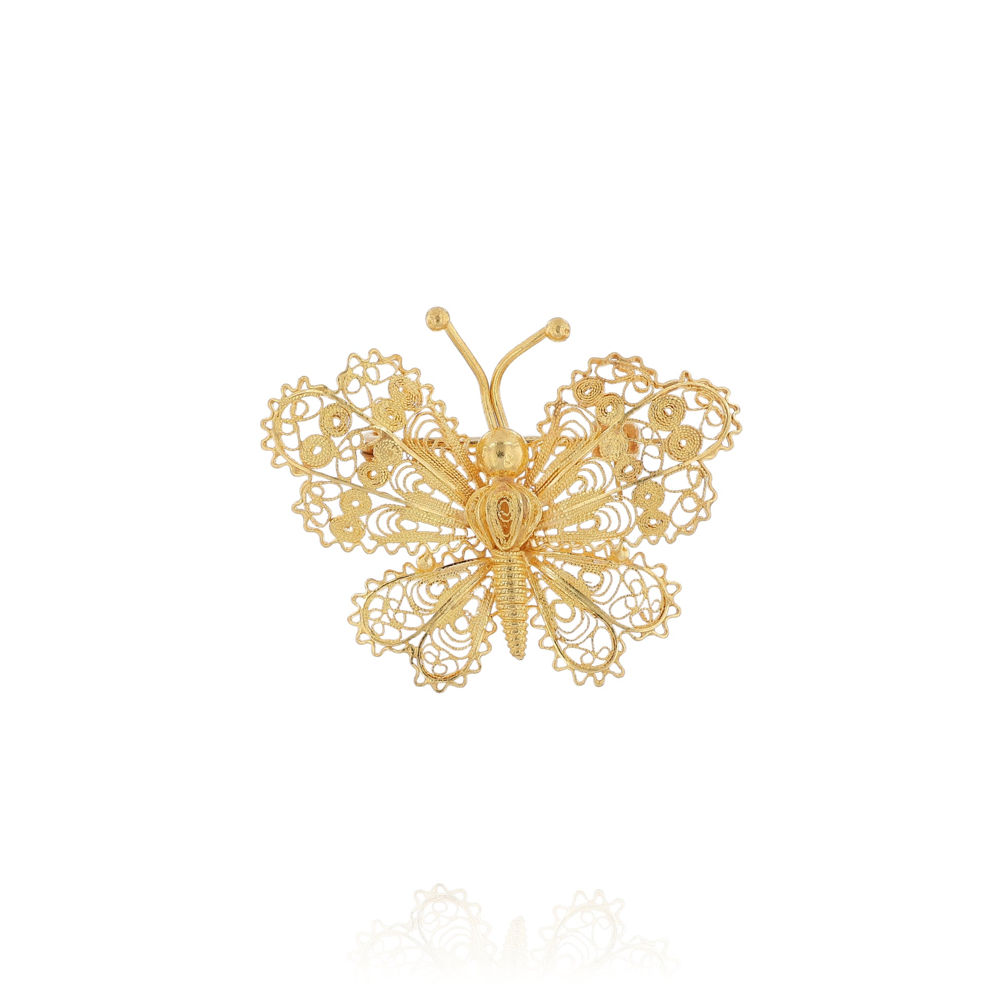 Yellow gold filigree design butterfly pin on a white background