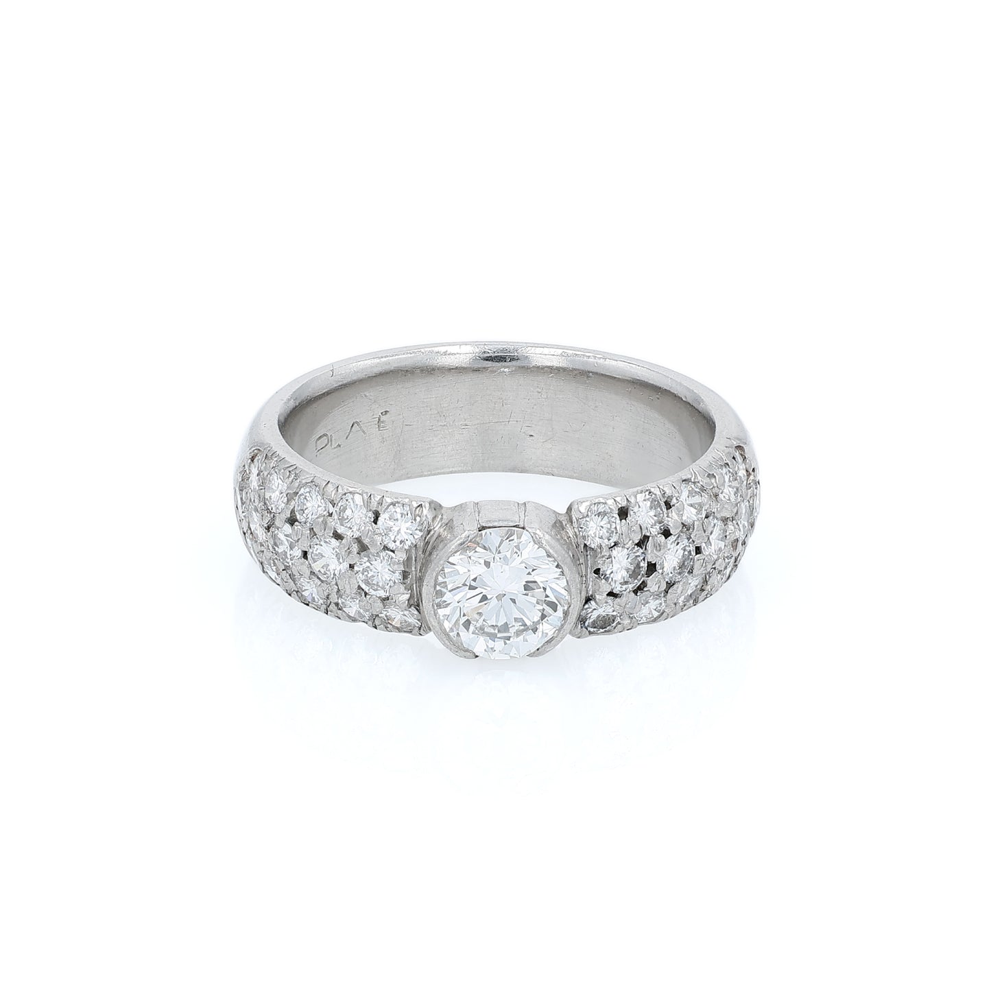 Platinum ring with a bezel set diamond center and pave diamonds on the shank on a white background