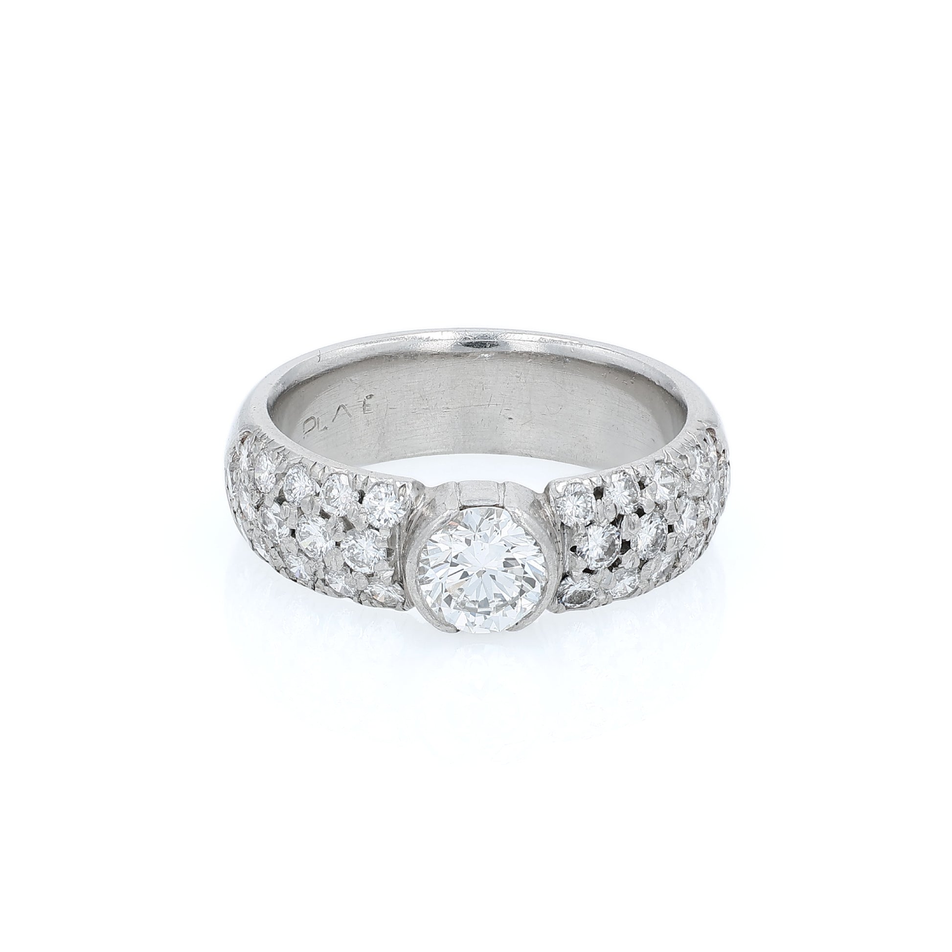 Platinum ring with a bezel set diamond center and pave diamonds on the shank on a white background