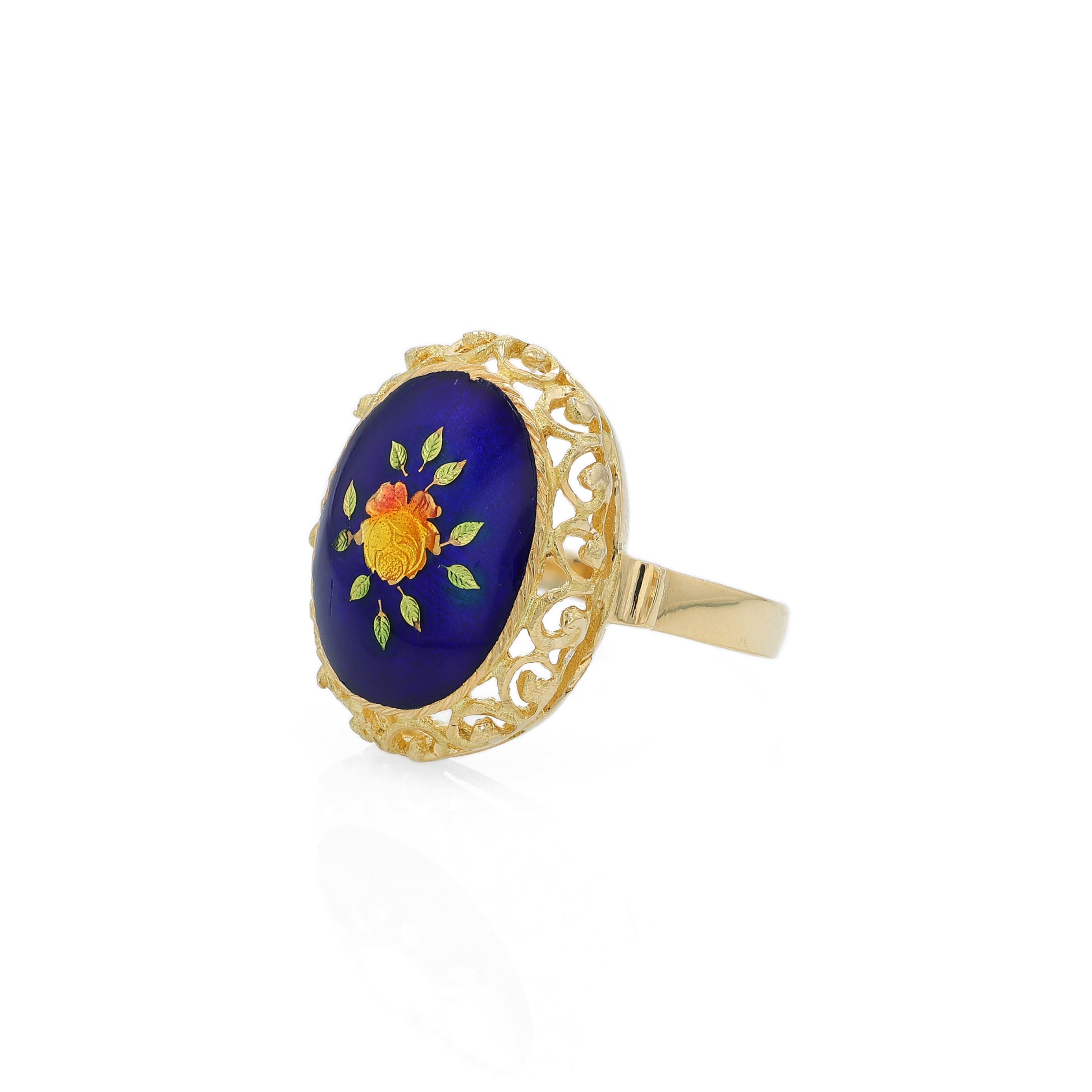 Yellow gold ring with a blue, orange and green flower design enamel center on a white background