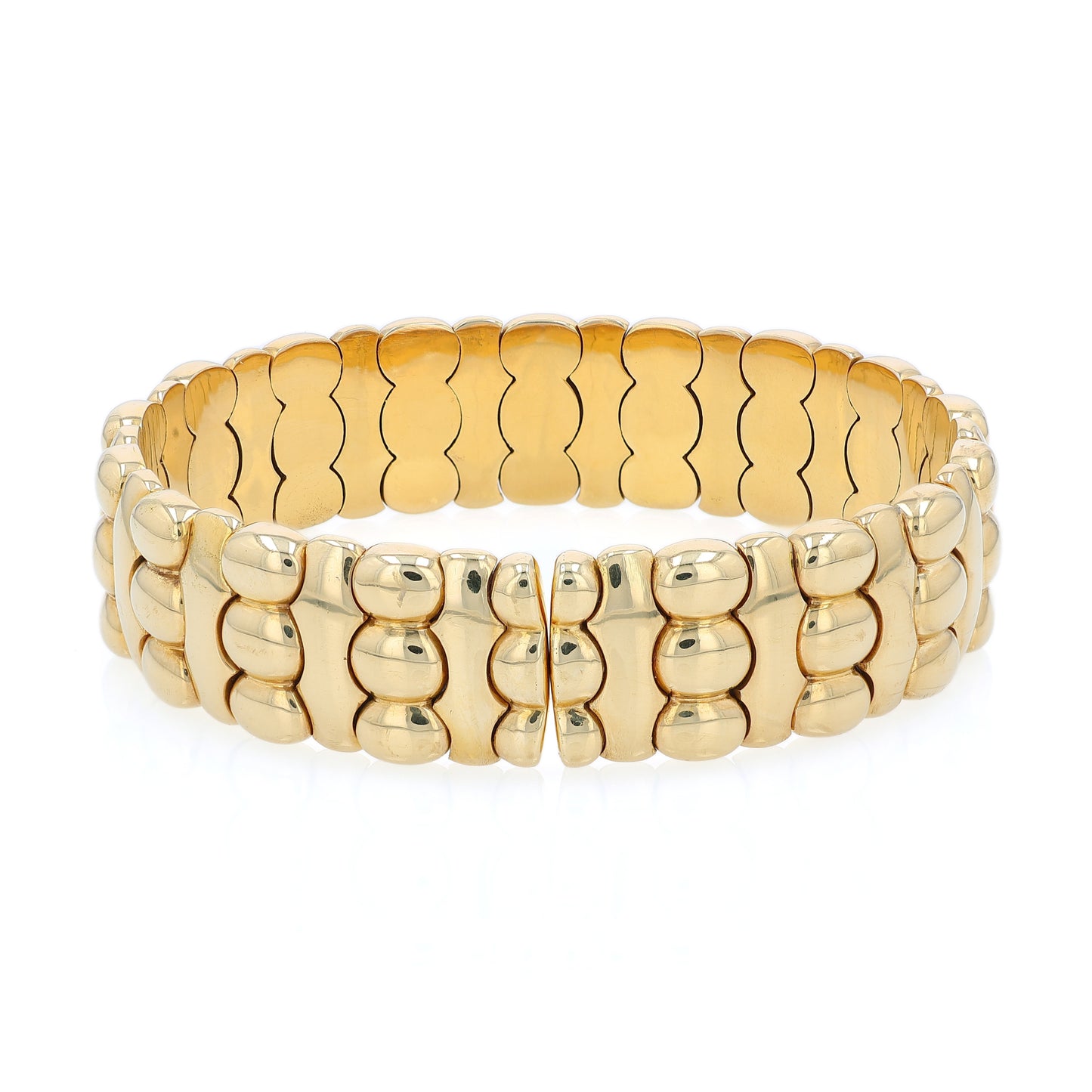 Yellow gold diamond and cabochon sapphire flexible cuff bracelet on a white background
