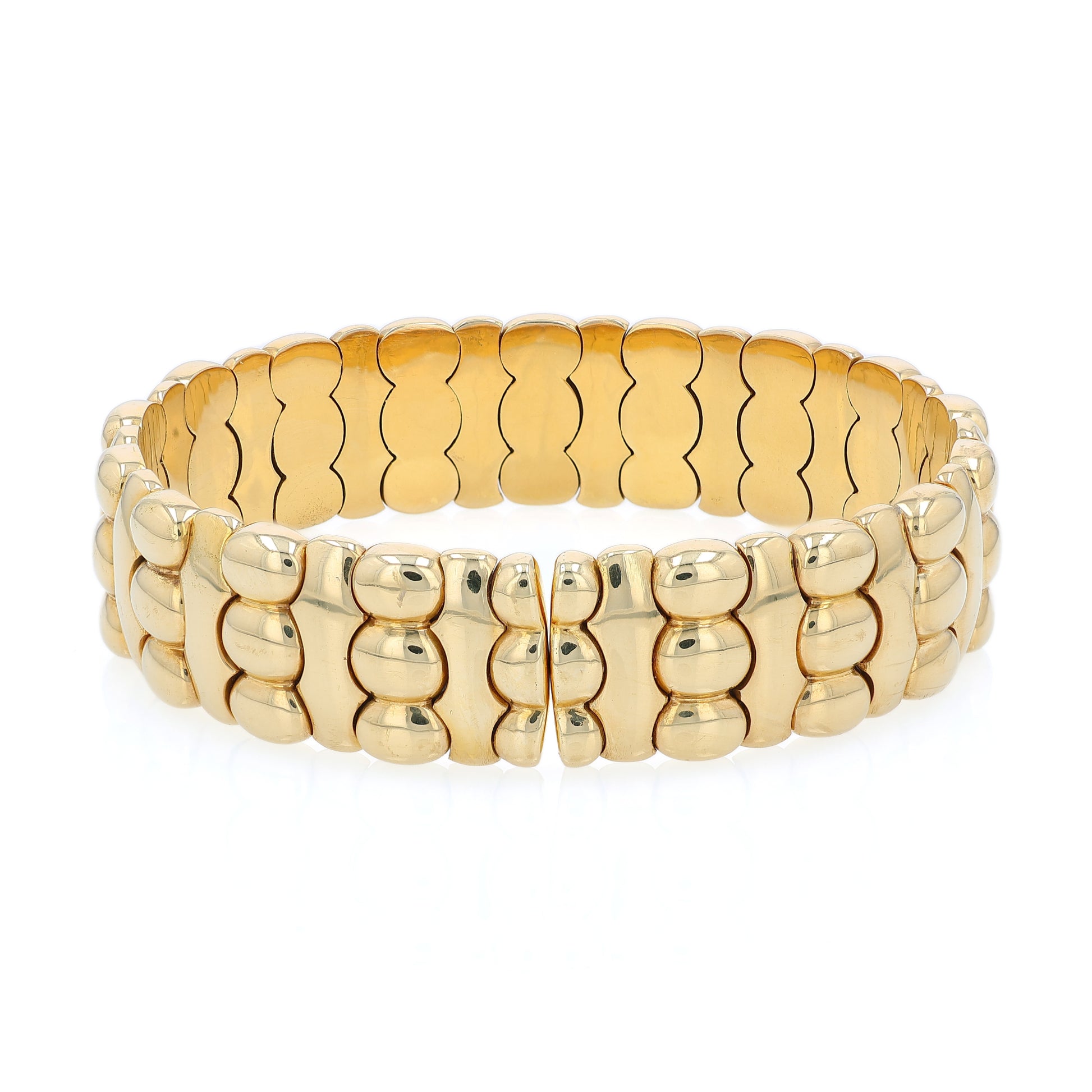 Yellow gold diamond and cabochon sapphire flexible cuff bracelet on a white background