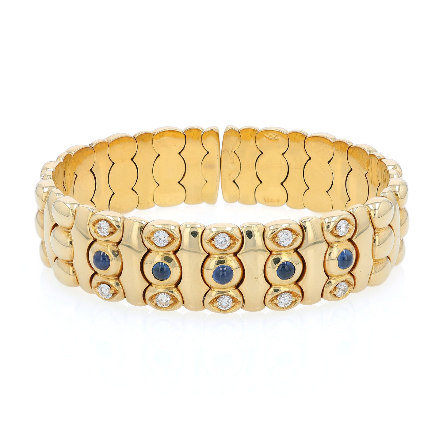 Yellow gold diamond and cabochon sapphire flexible cuff bracelet on a white background