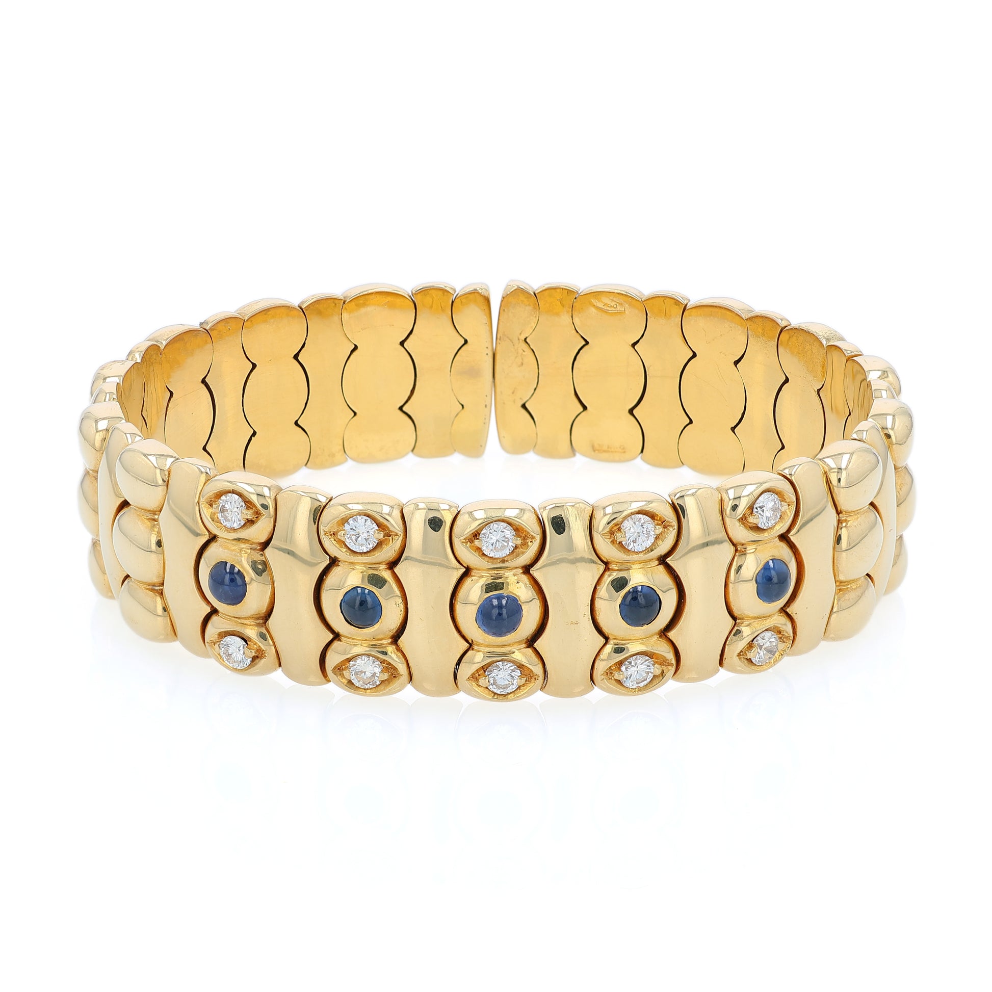 Yellow gold diamond and cabochon sapphire flexible cuff bracelet on a white background