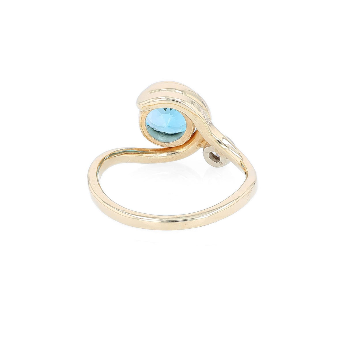 Yellow gold bezel set blue topaz and diamond ring on a white background