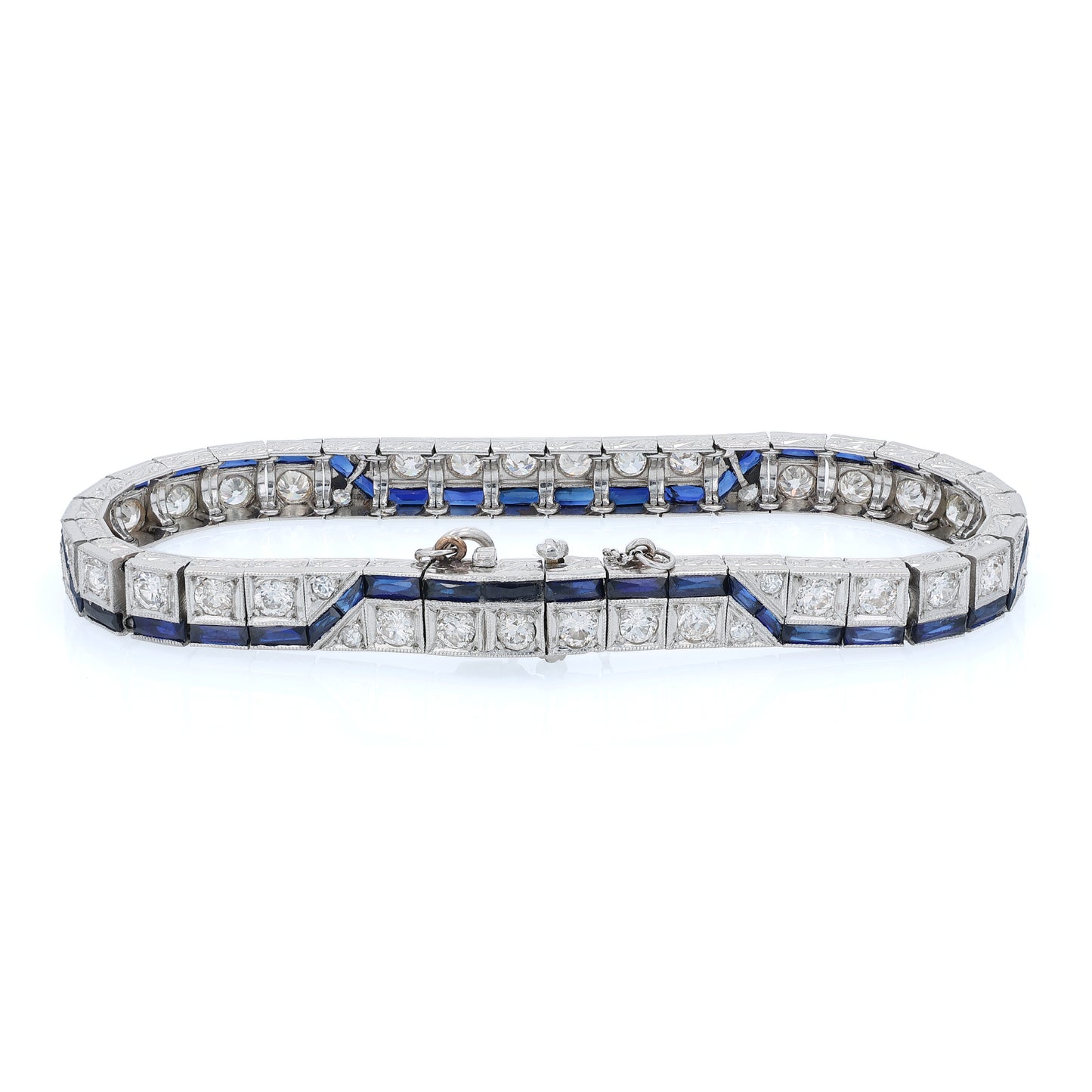 Platinum diamond bracelet with synthetic sapphire accents on a white background