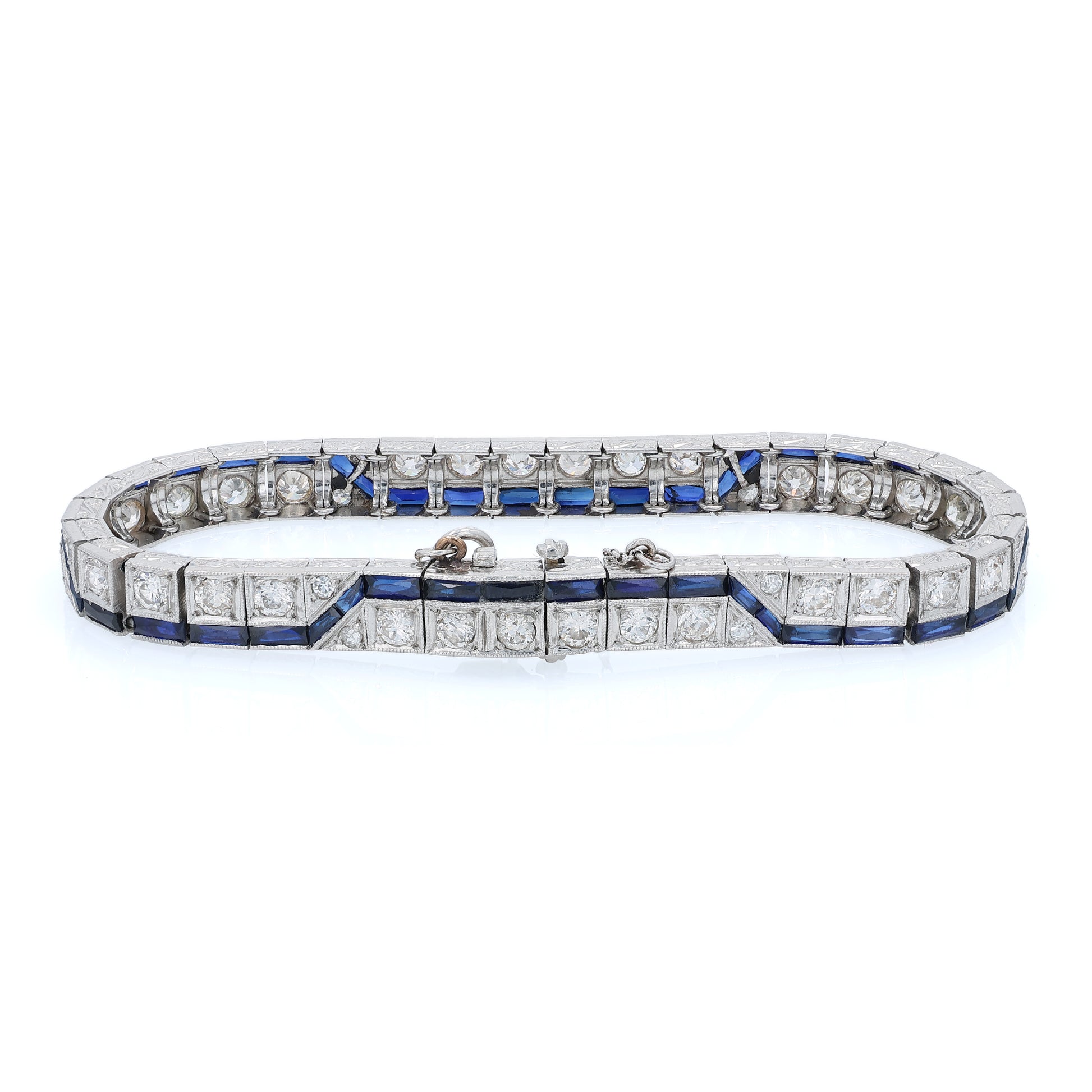 Platinum diamond bracelet with synthetic sapphire accents on a white background