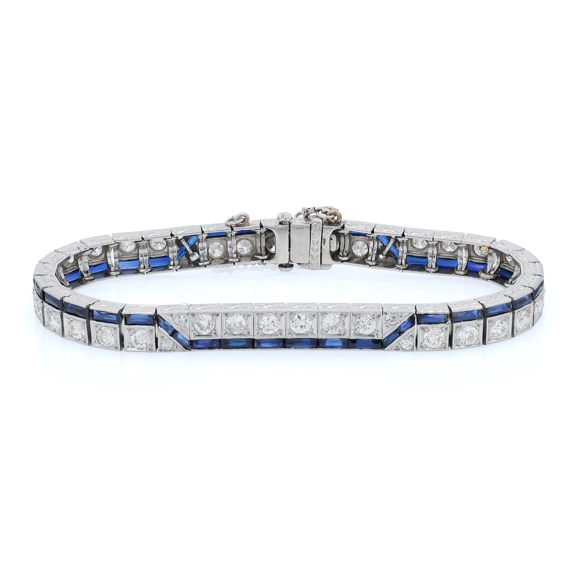 Platinum diamond bracelet with synthetic sapphire accents on a white background